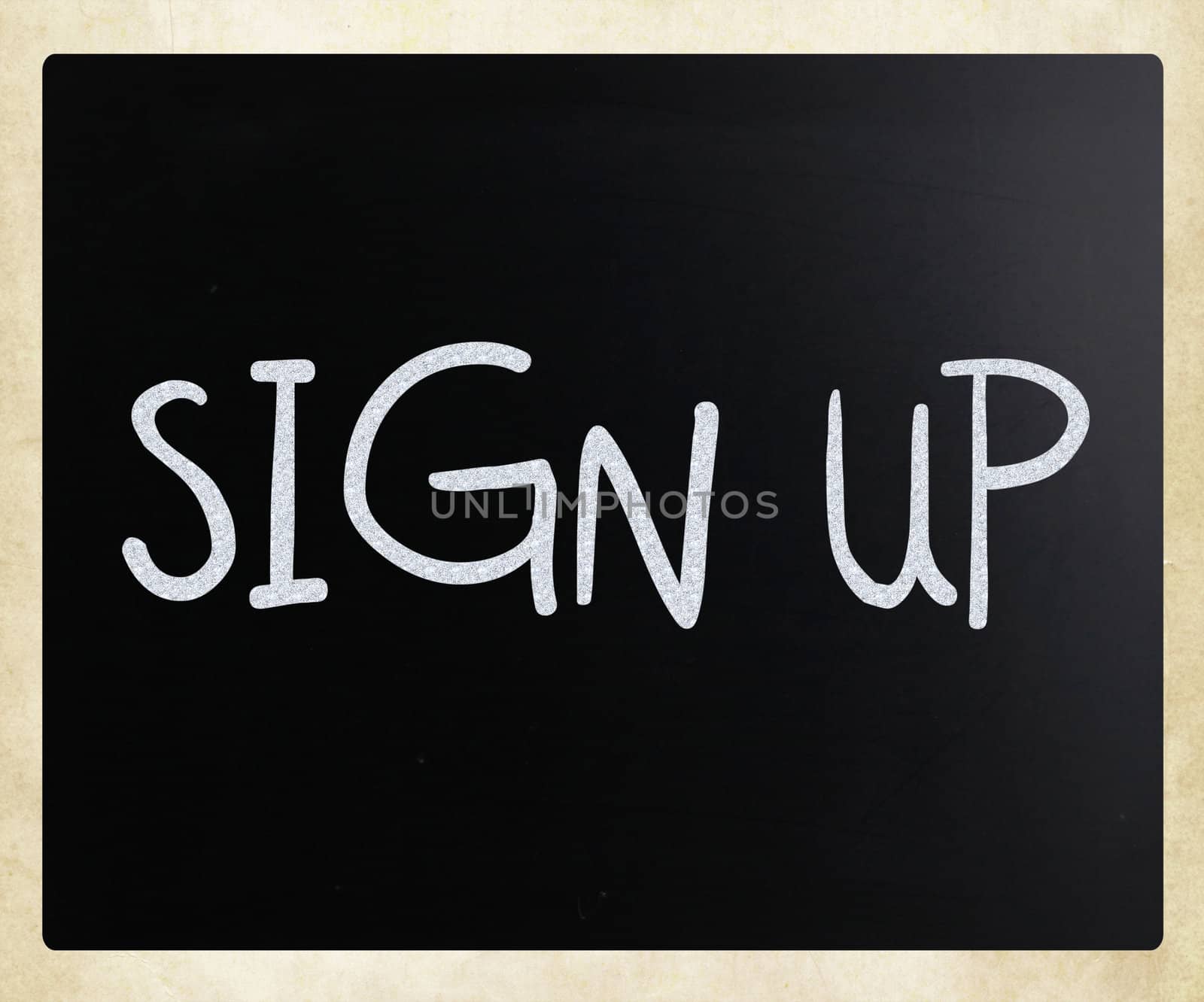 "Sign up" handwritten with white chalk on a blackboard