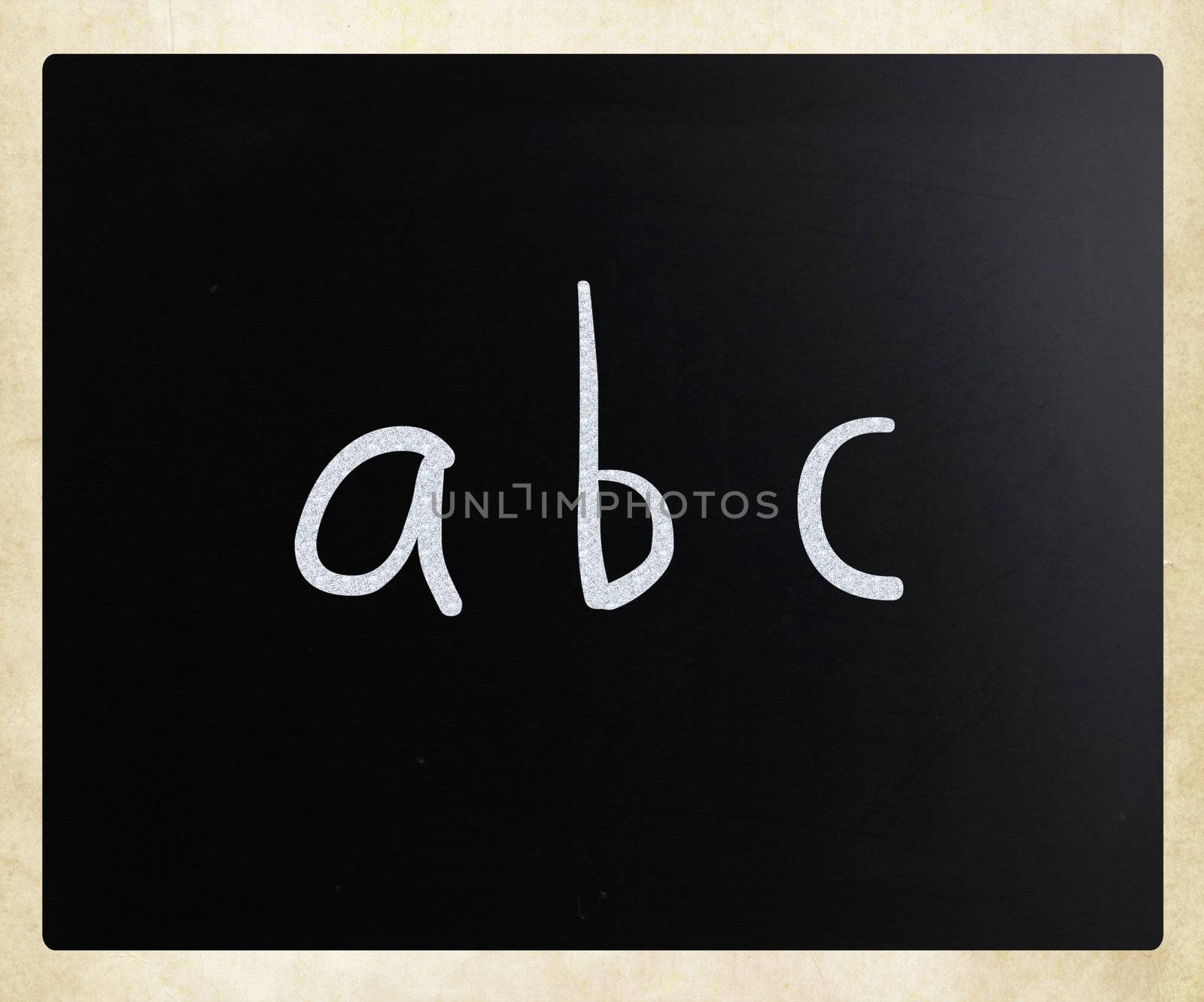 "abc" handwritten with white chalk on a blackboard