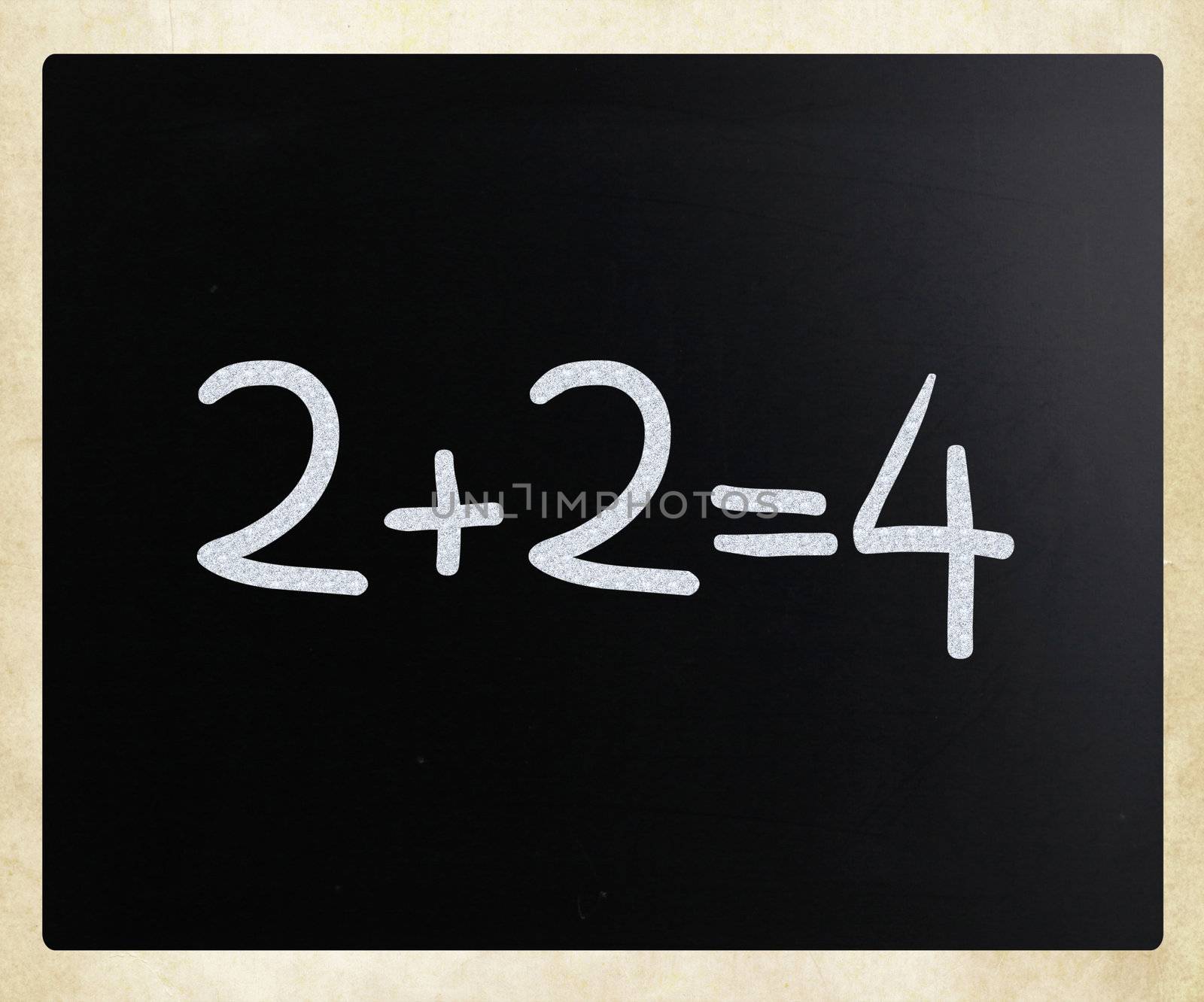 "2+2=4" handwritten with white chalk on a blackboard