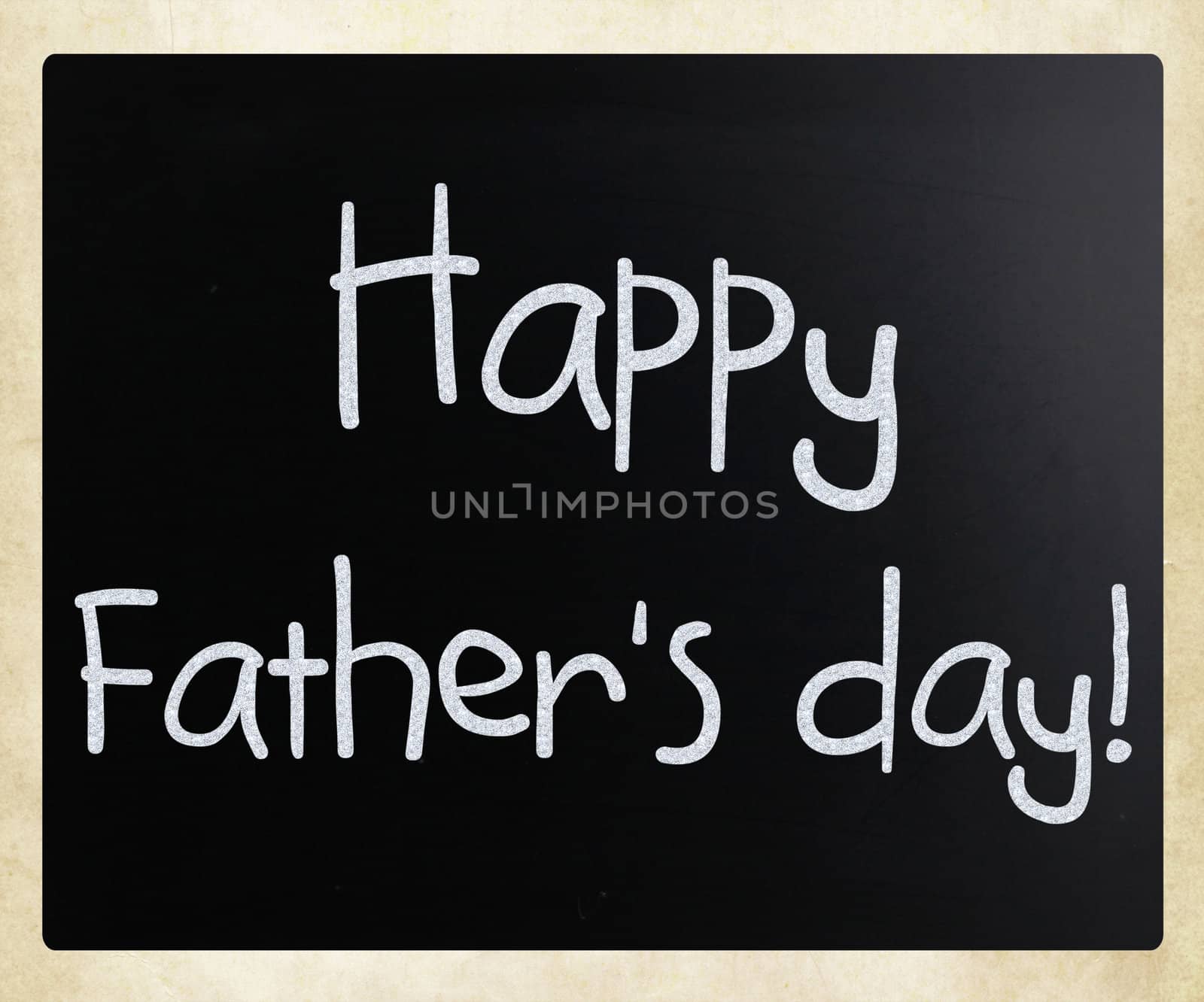 "Happy father's day" handwritten with white chalk on a blackboard