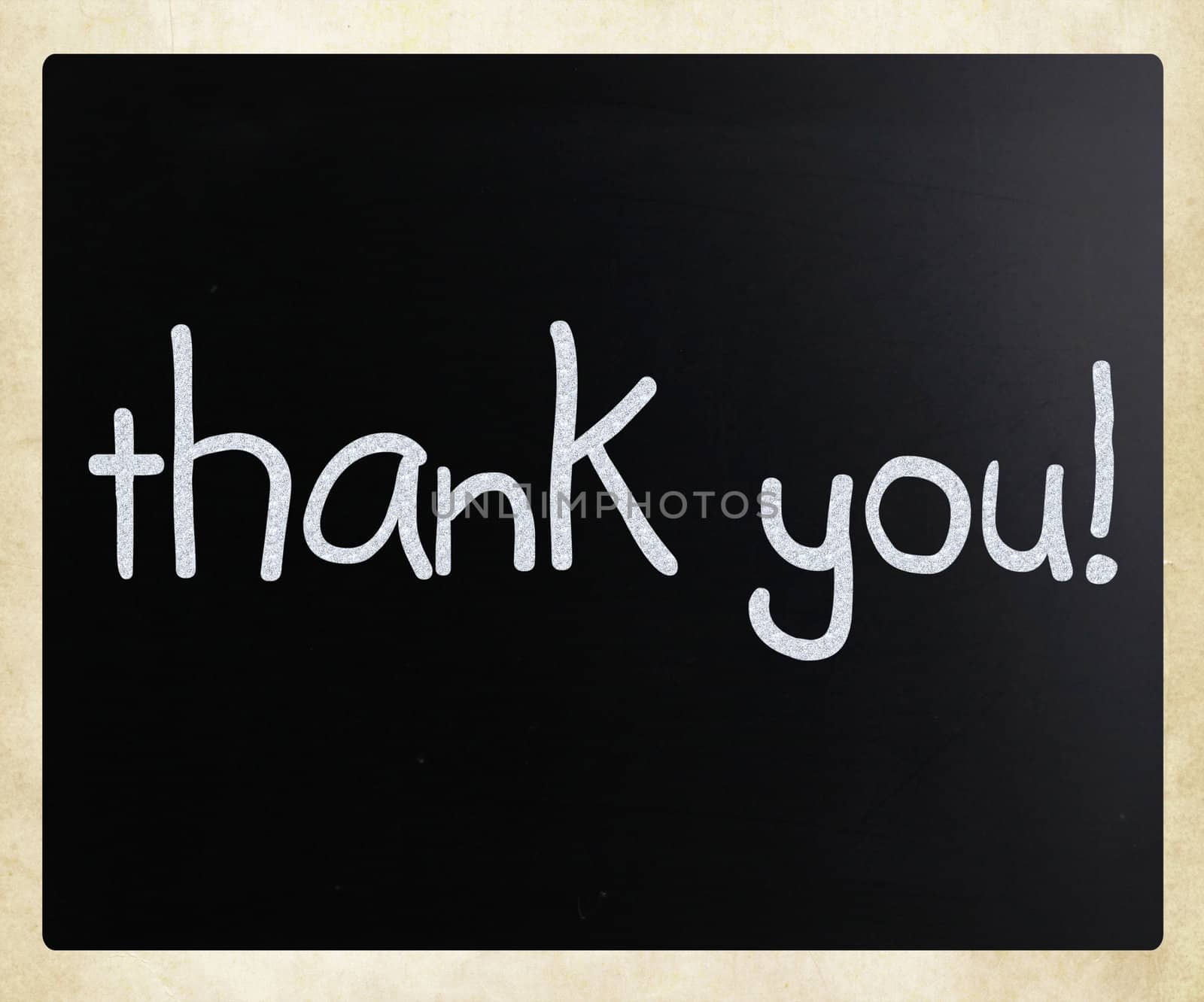 "Thank you" handwritten with white chalk on a blackboard