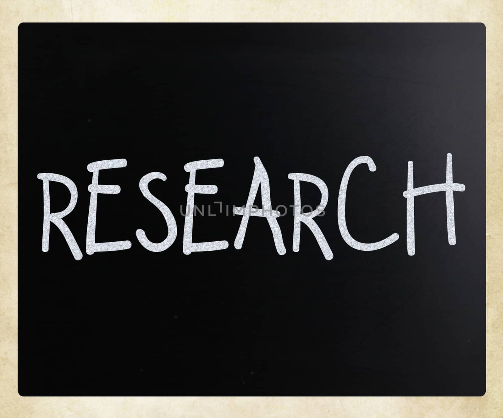 "Research" handwritten with white chalk on a blackboard