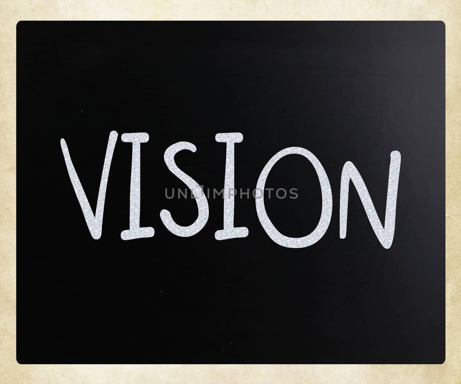 "Vision" handwritten with white chalk on a blackboard