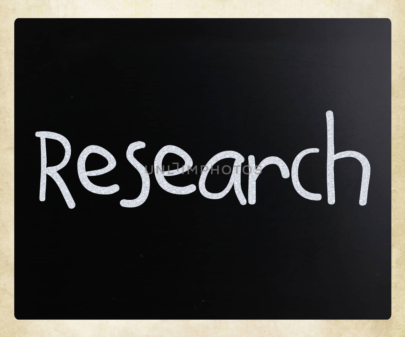 "Research" handwritten with white chalk on a blackboard