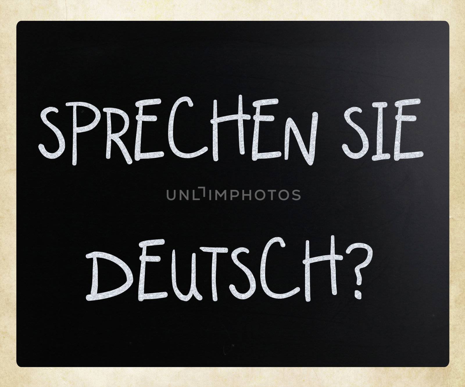 "Sprechen Sie Deutsch?" handwritten with white chalk on a blackboard