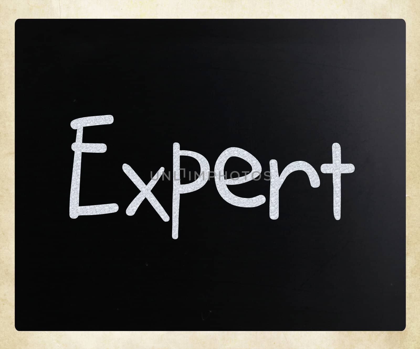 The word "Expert" handwritten with white chalk on a blackboard
