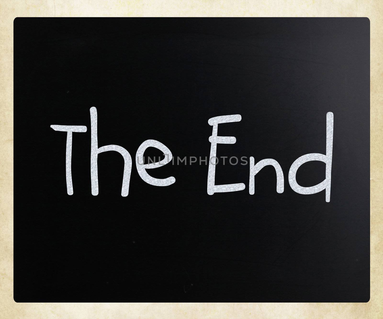 "The End" handwritten with white chalk on a blackboard