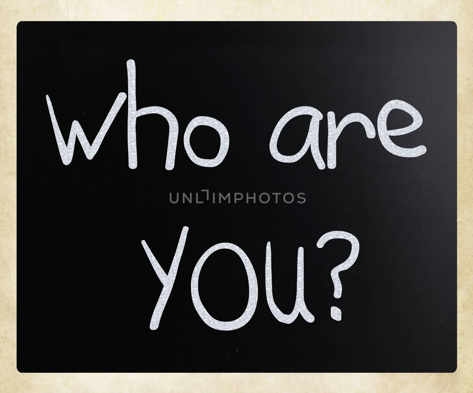 "Who are you" handwritten with white chalk on a blackboard