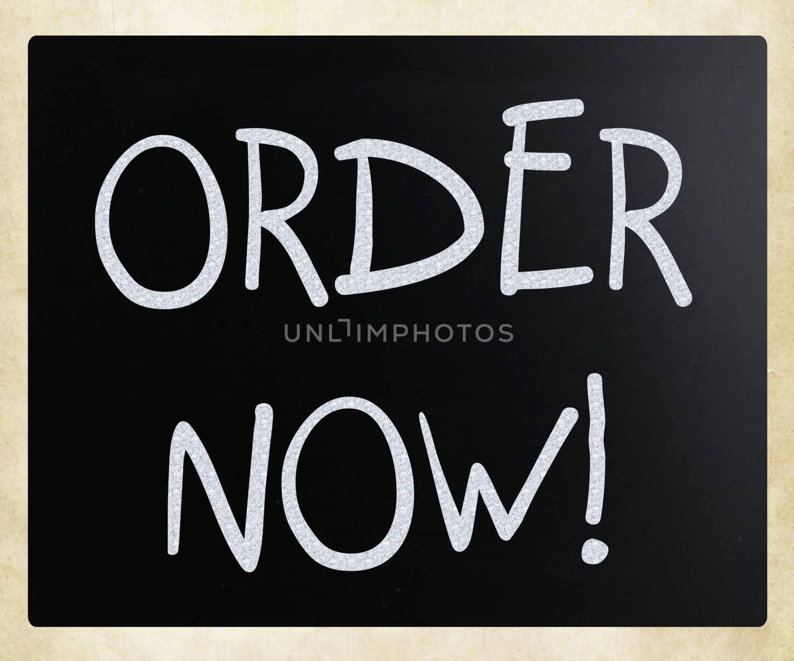 "Order now" handwritten with white chalk on a blackboard