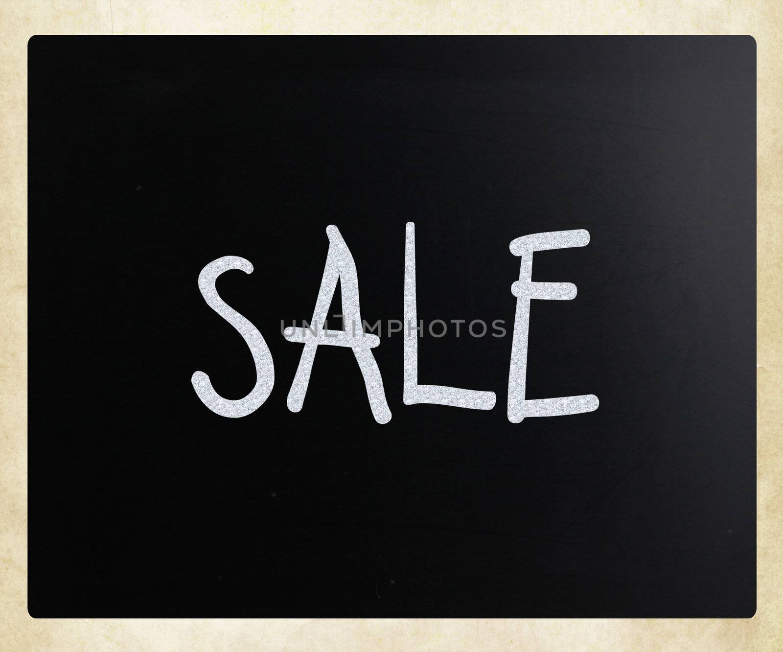 "Sale" handwritten with white chalk on a blackboard