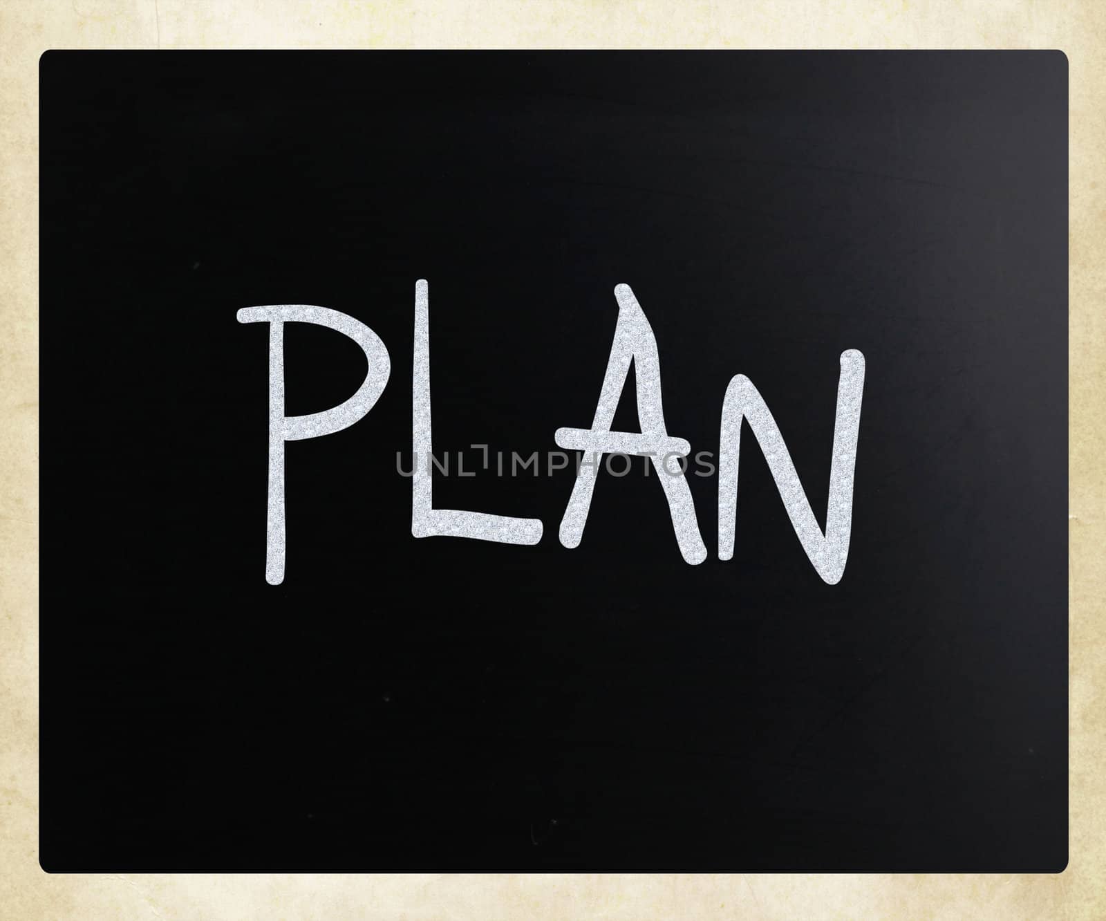 "Plan" handwritten with white chalk on a blackboard
