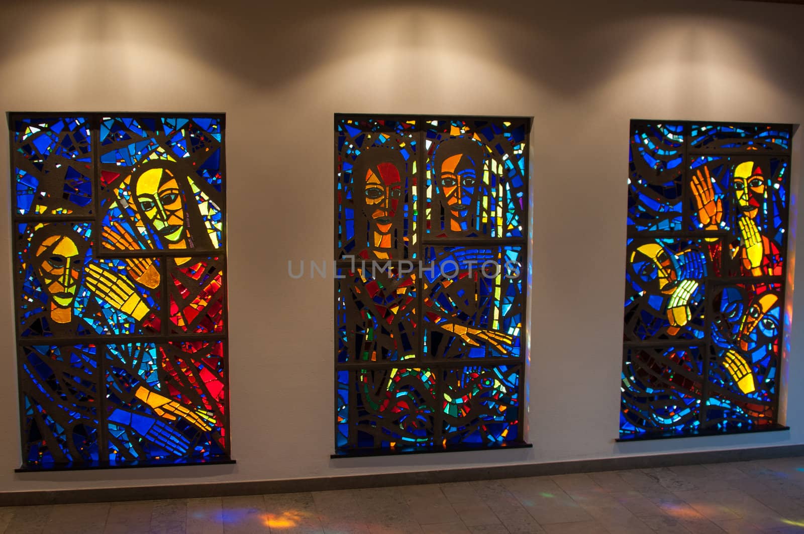 bright stained-glass church windows picturing religious scenes