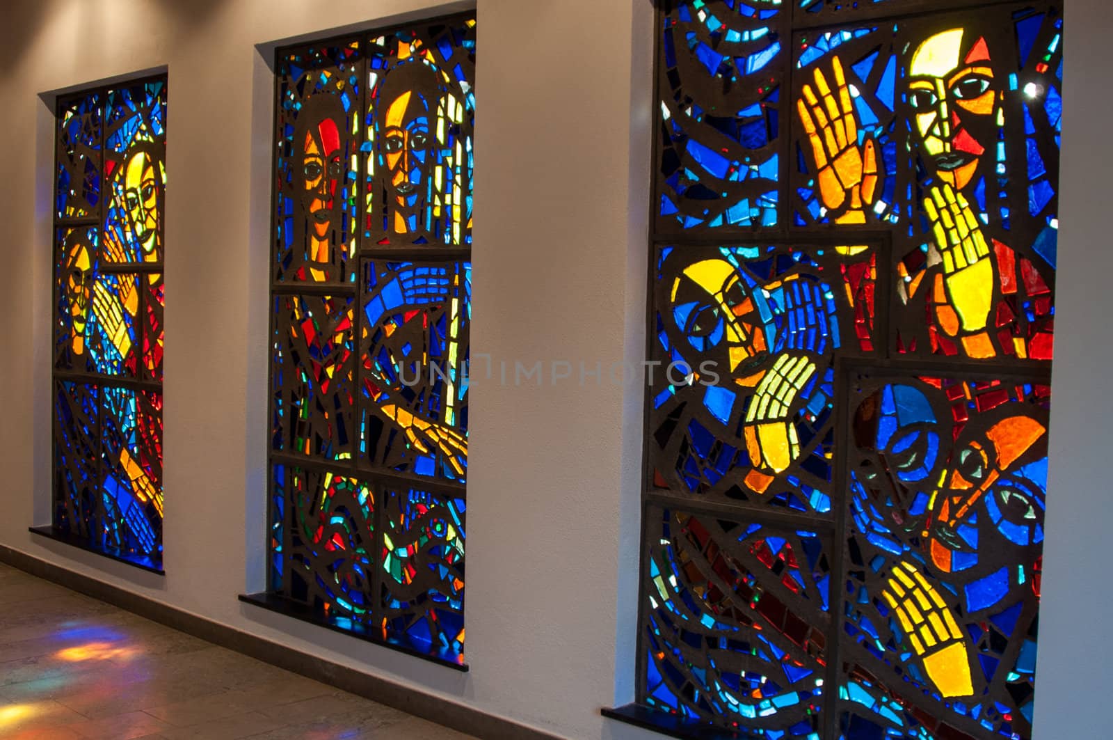 bright stained-glass church windows picturing religious scenes