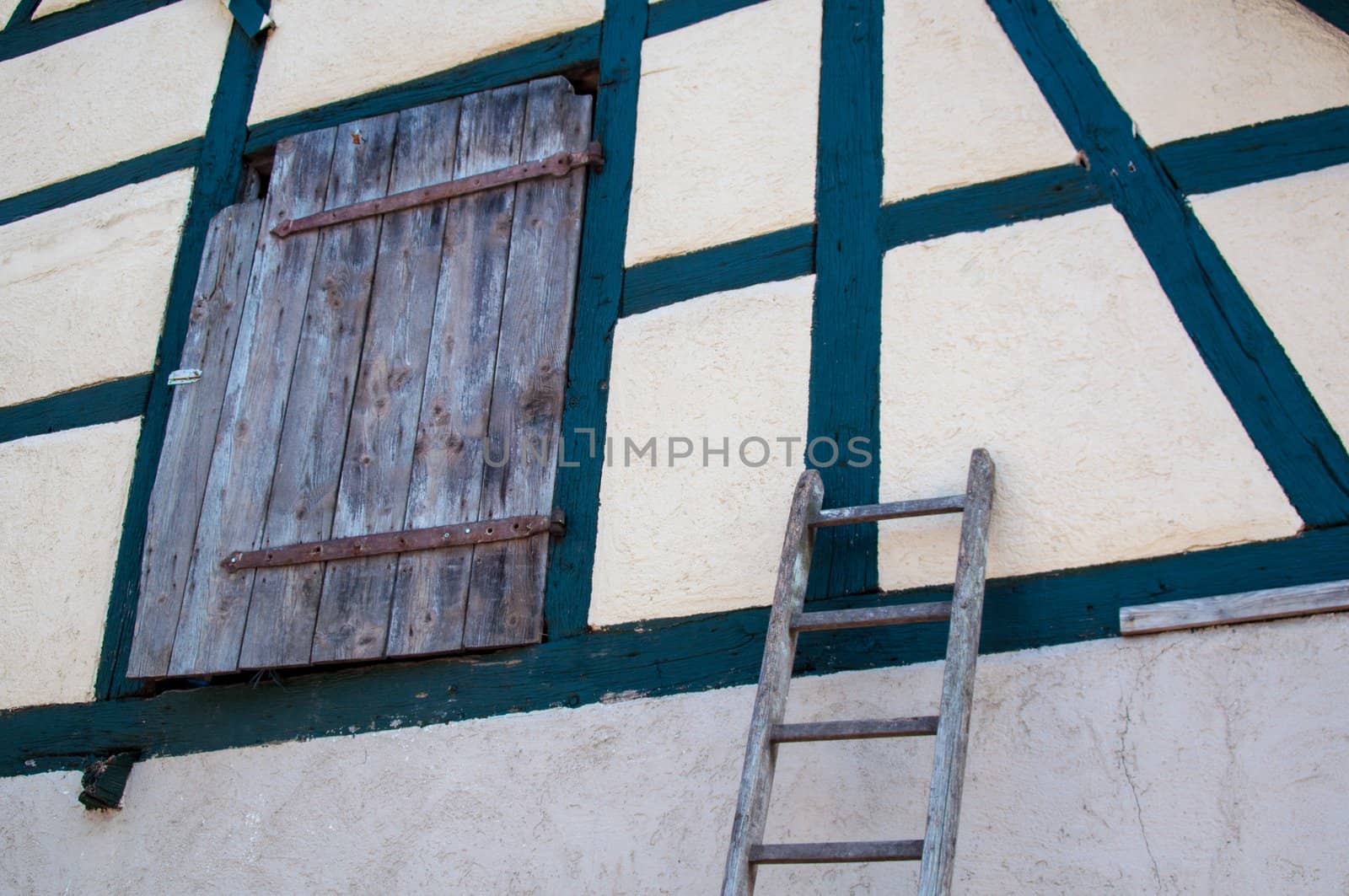 an old half timbered barn with door and ladder