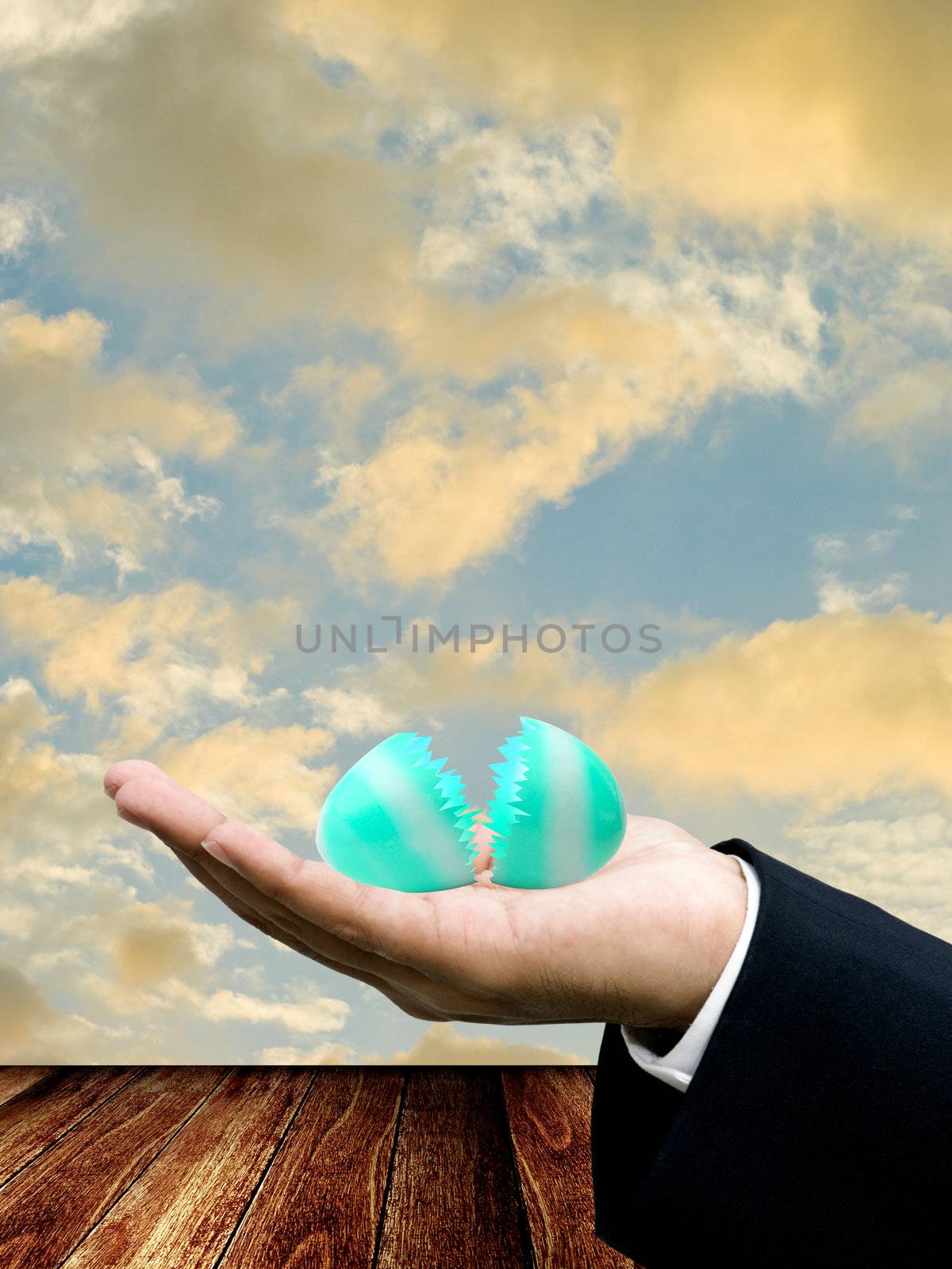 Broken easter egg on wooden table by pixbox77