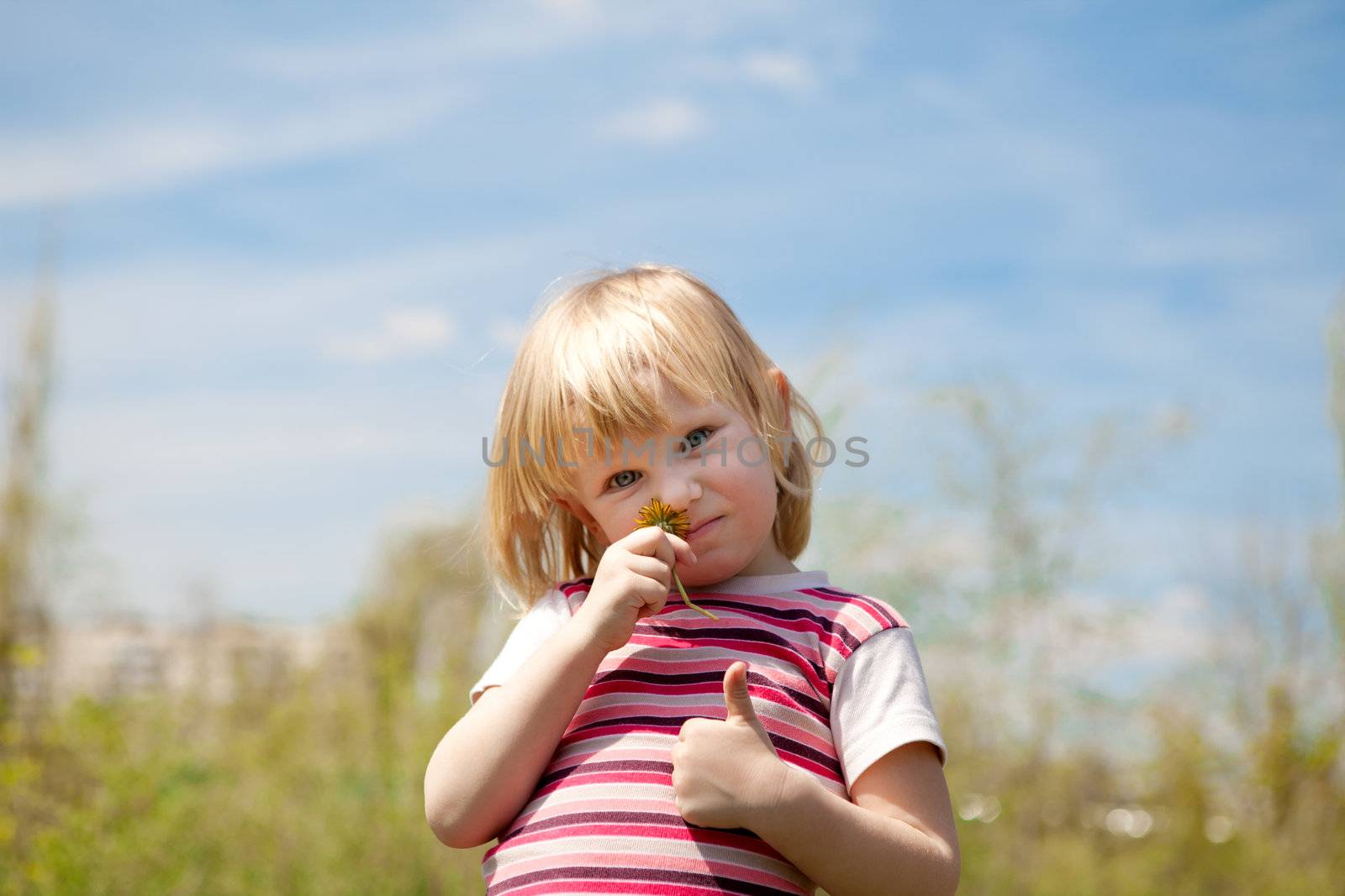 happy child outdoors in spring with dandelion