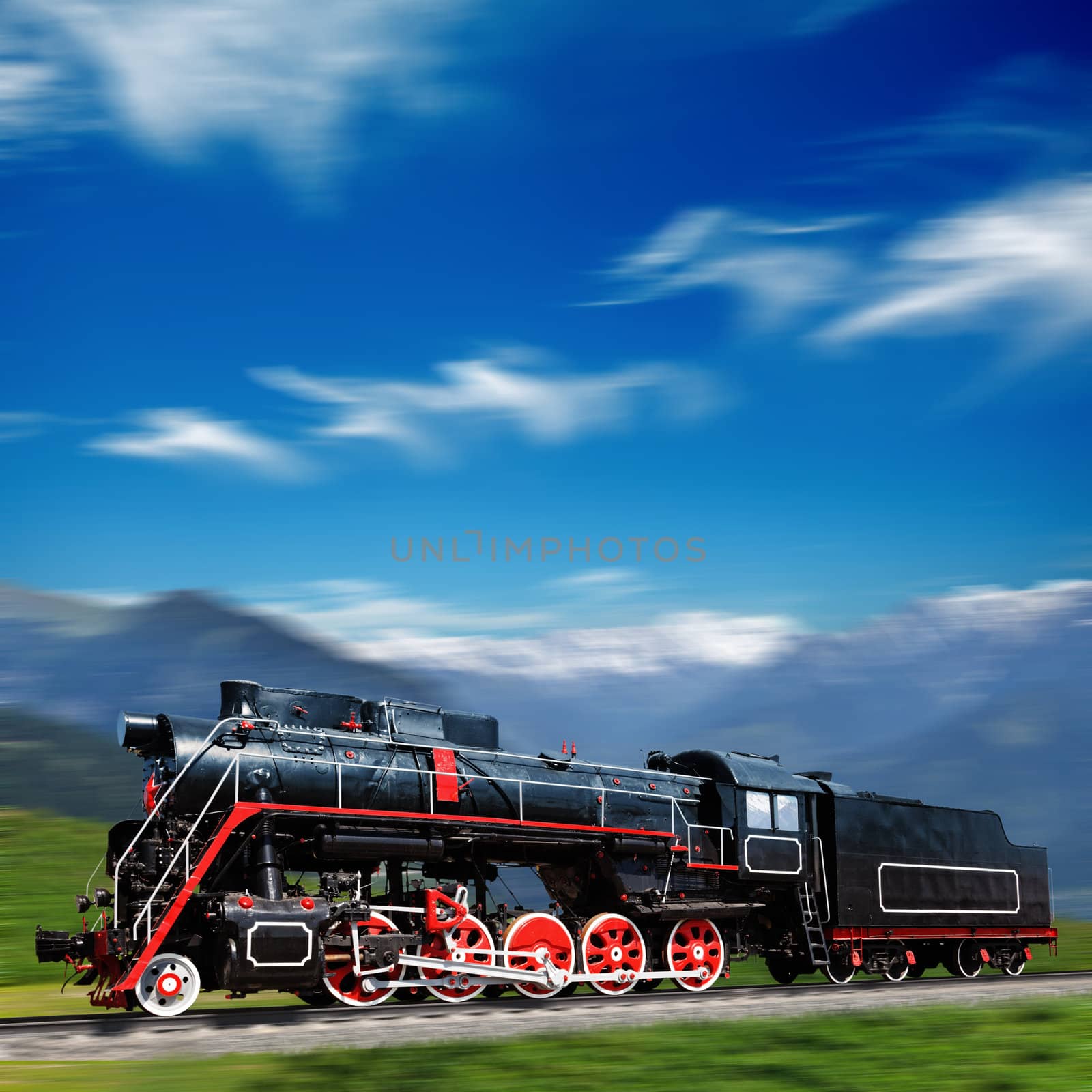 Speeding old locomotive in mountains with motion blur by dimol