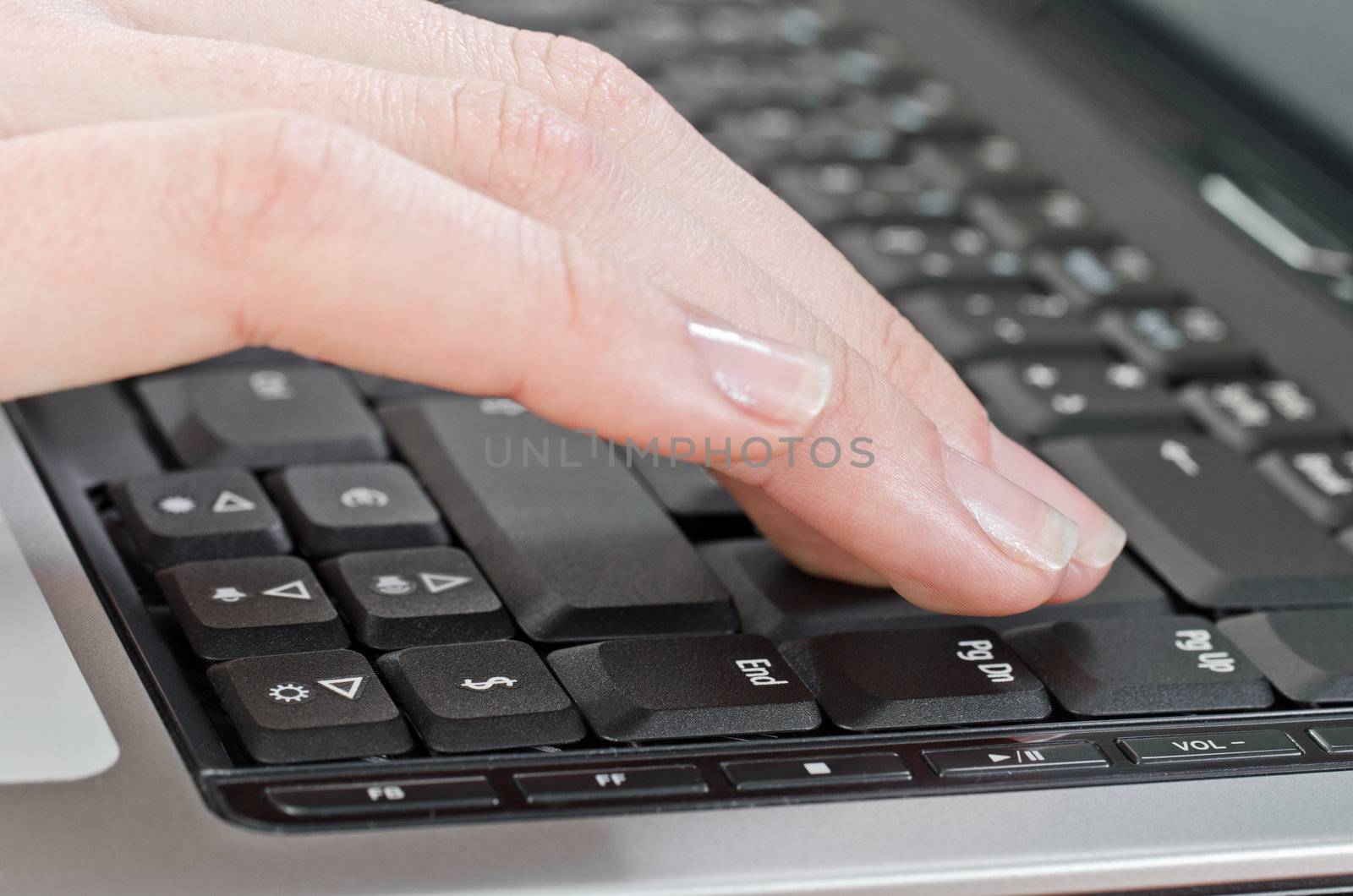 female hand pressing key on the laptop