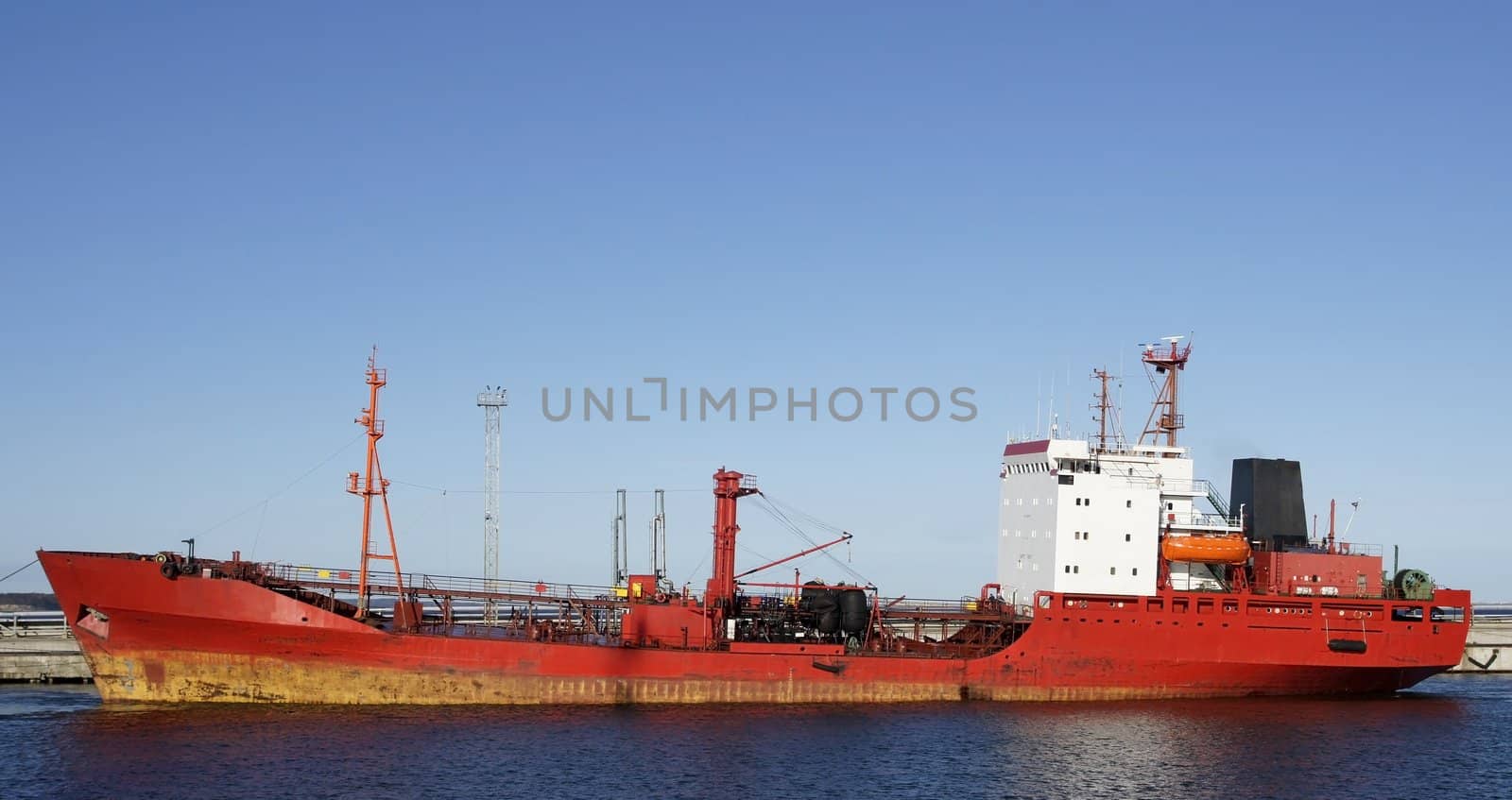 The tanker is moored in the port and loaded fuel