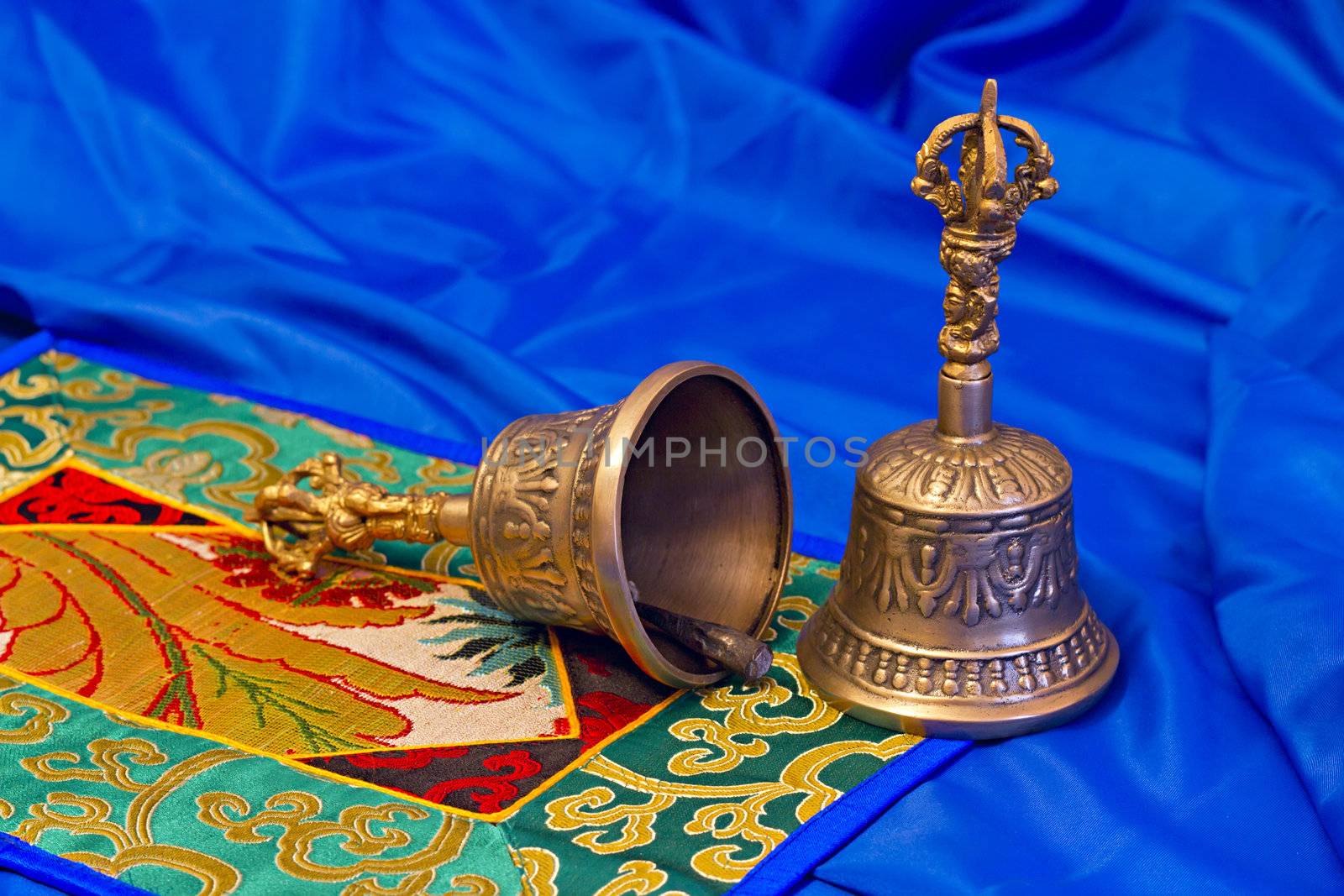 two Tibetan ritual bells on a blue background