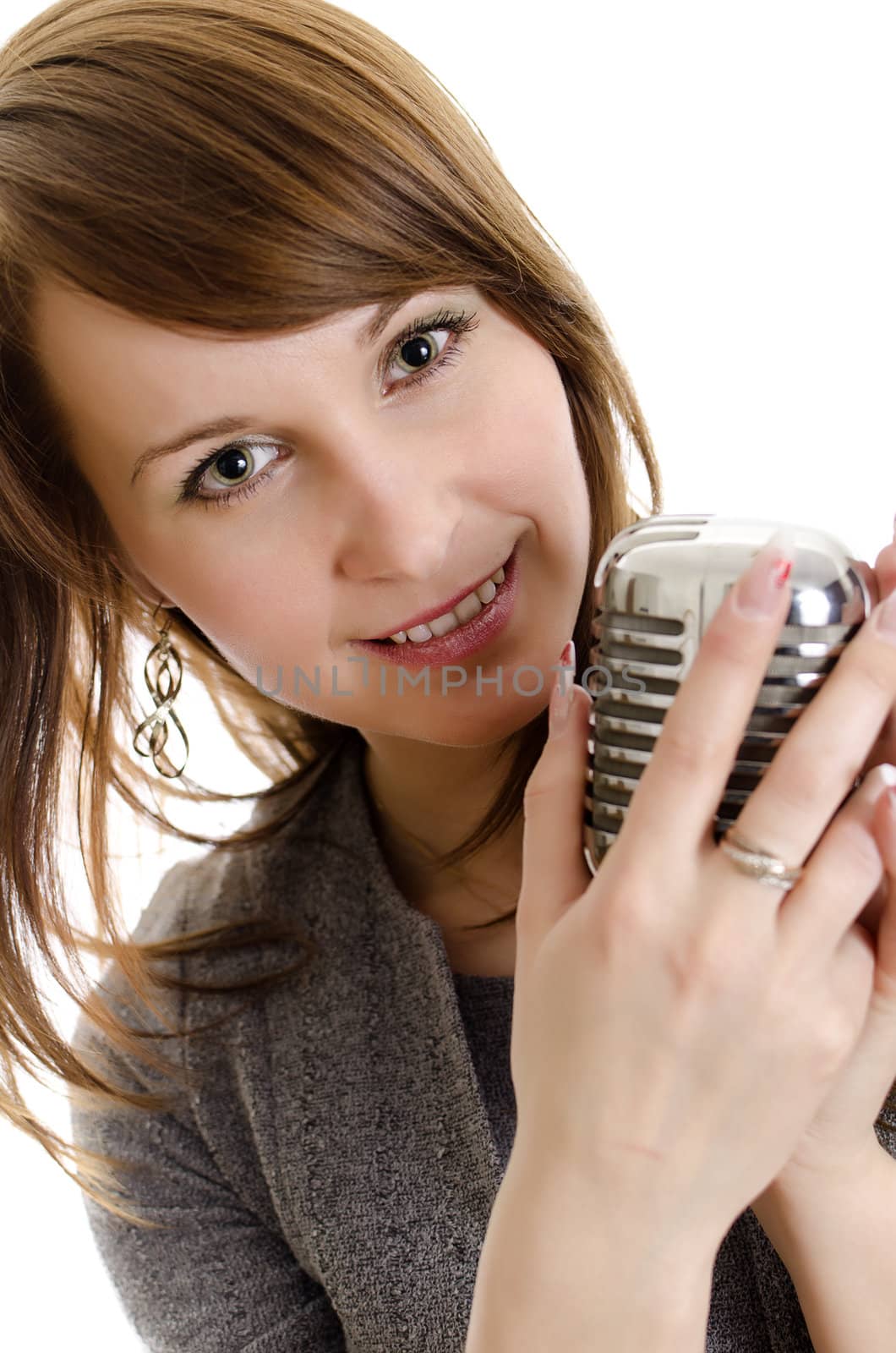 Young woman holding a retro-microphone. Isolated on white.