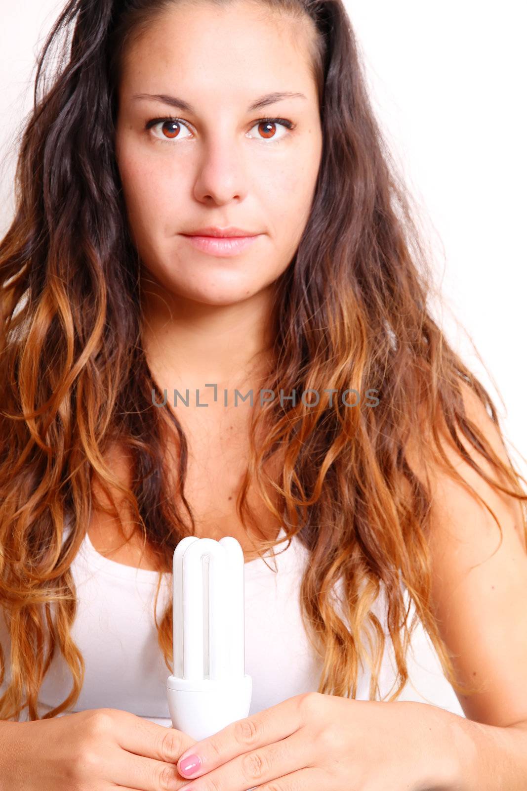 Young girl with a energy saver light bulb.