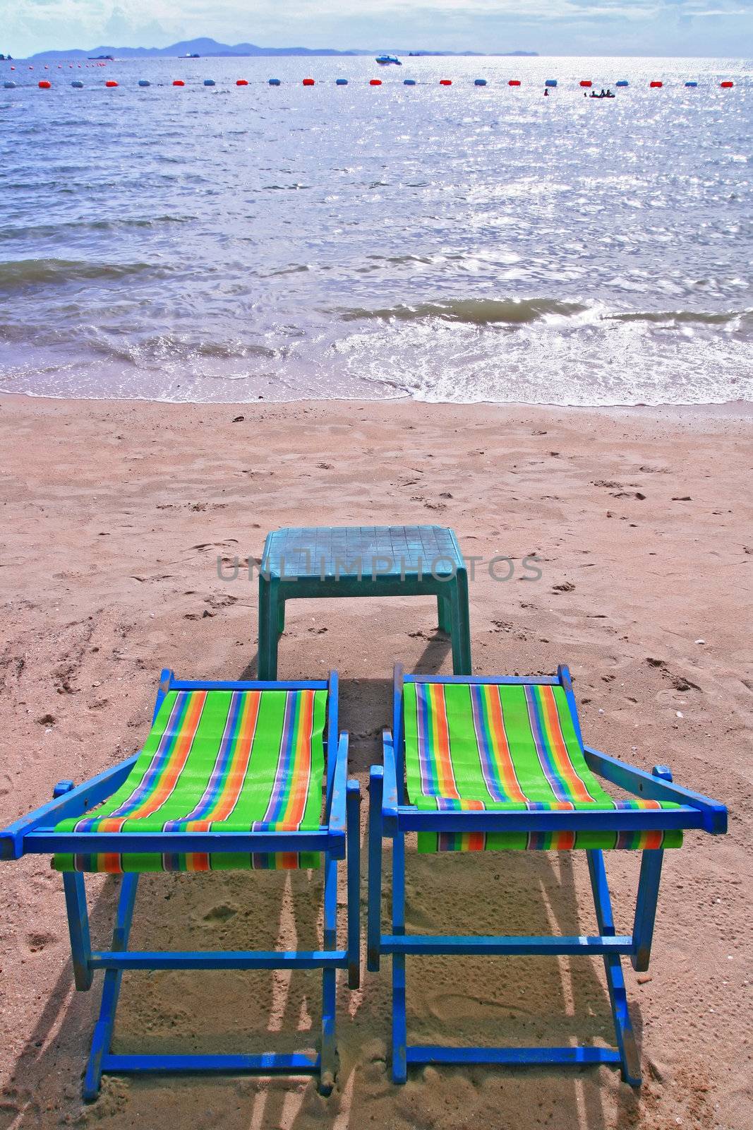 Couple of beach chairs and table on the beach in Pattaya City
