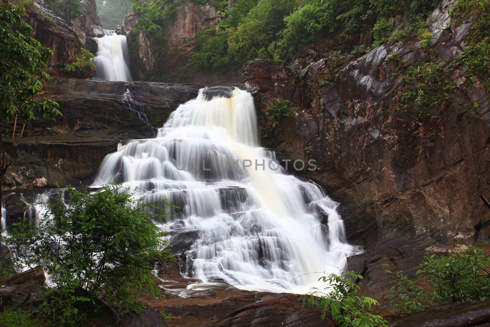 tropical rainforest waterfall in jungle of Thailand landscpae