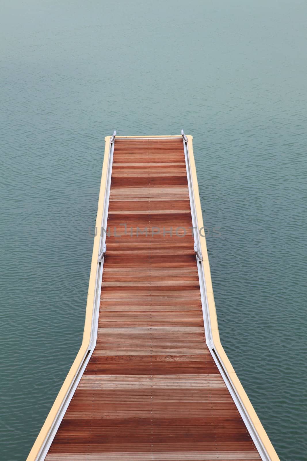 wooden jetty walkway and pathway pier of marina on sea