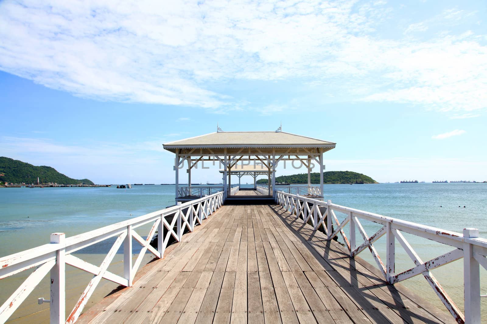 wooden jetty walkway with pavillion to the sea at Srichang Island Thailand with blue sky