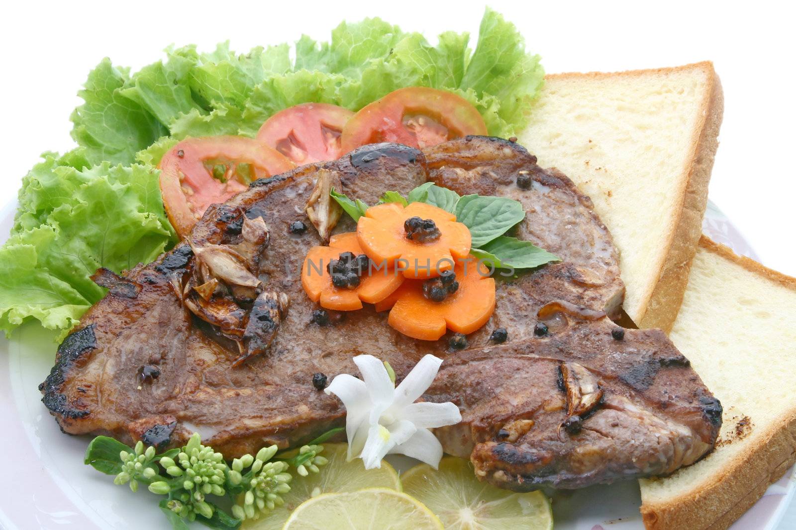 T Bone Pepper Steak with vegetable and bread, closeup