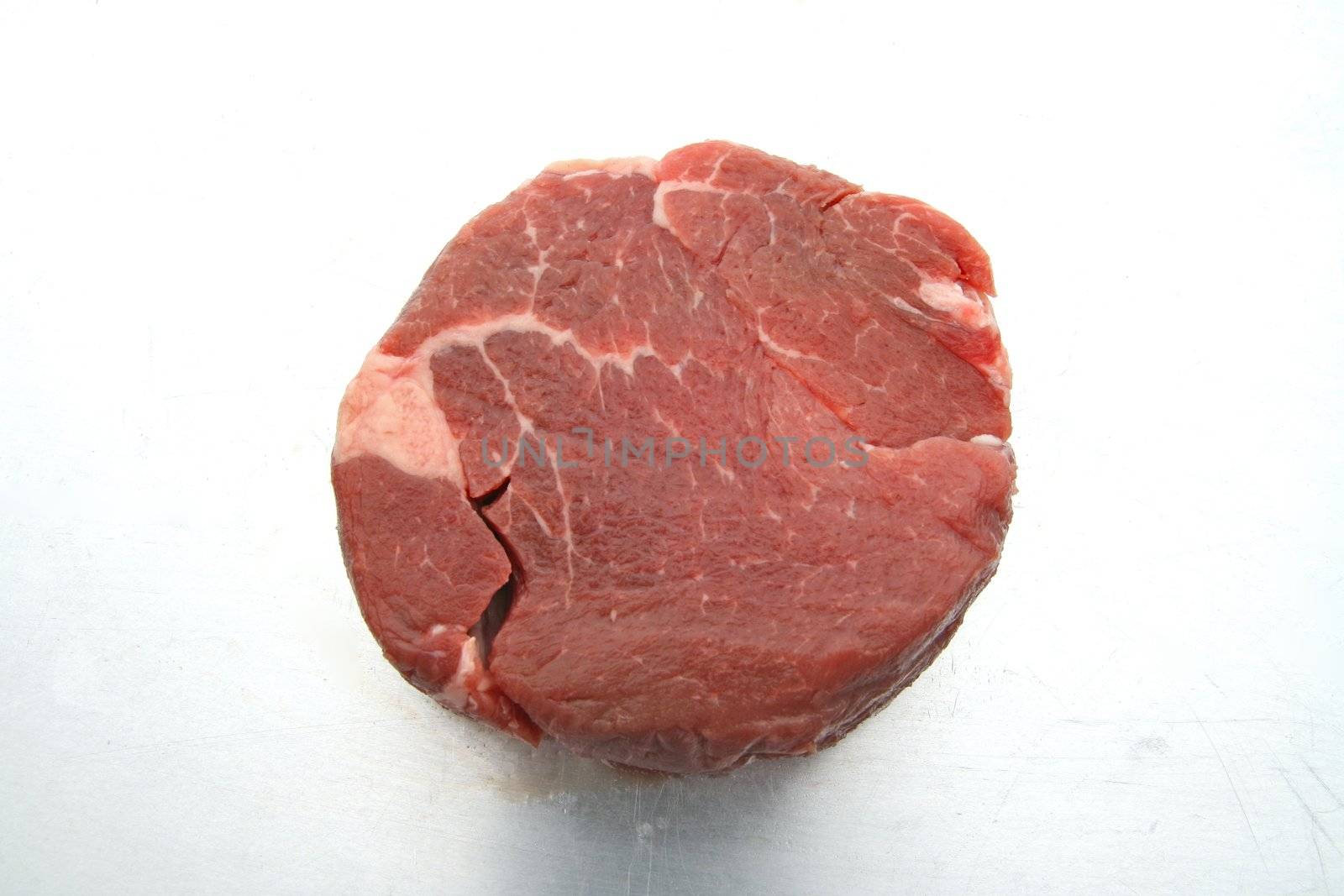 raw beef tender loin on steel plate