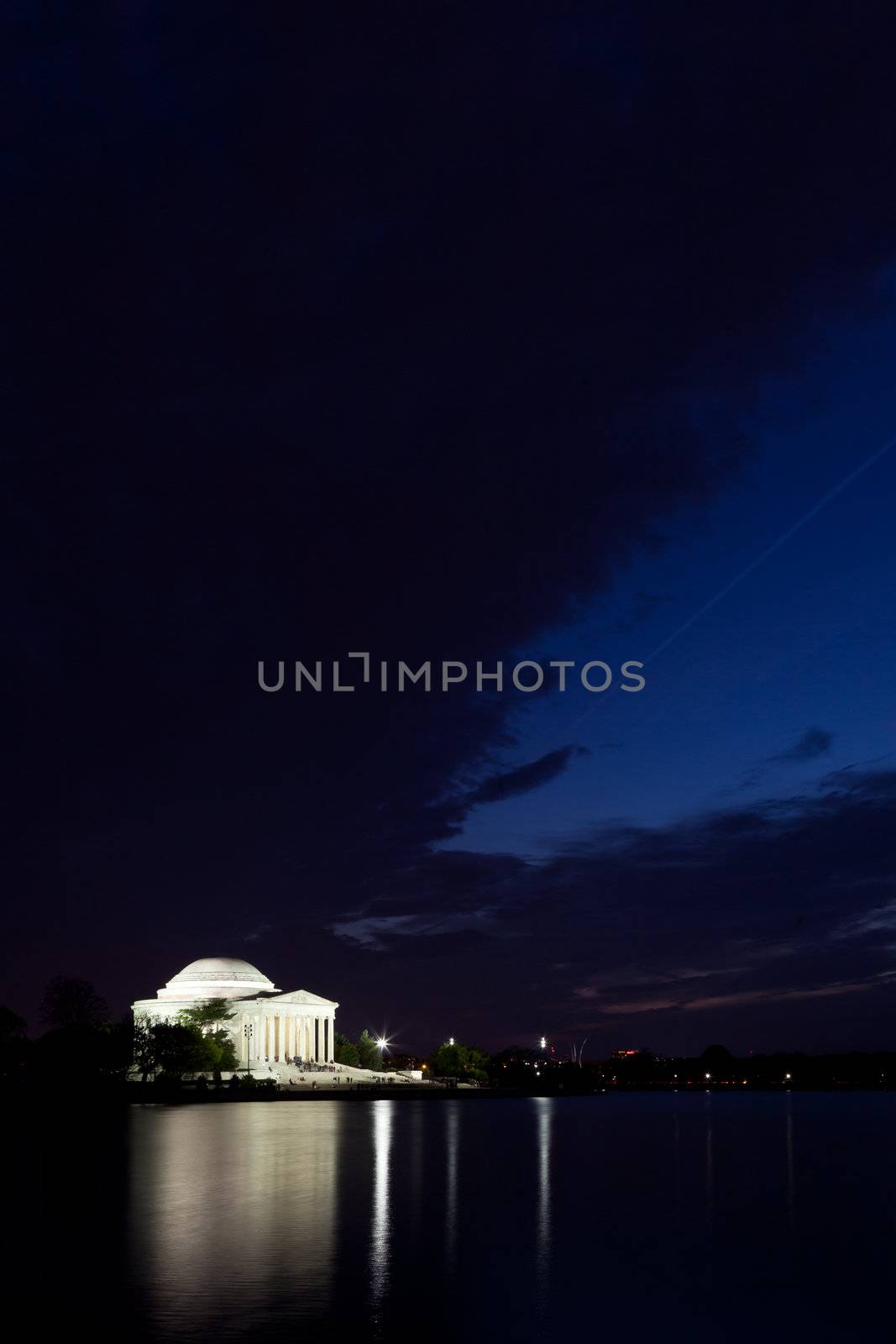 Thomas Jefferson Memorial with reflecting in the Tidal Basin in Washington DC at dusk with dramatic sky