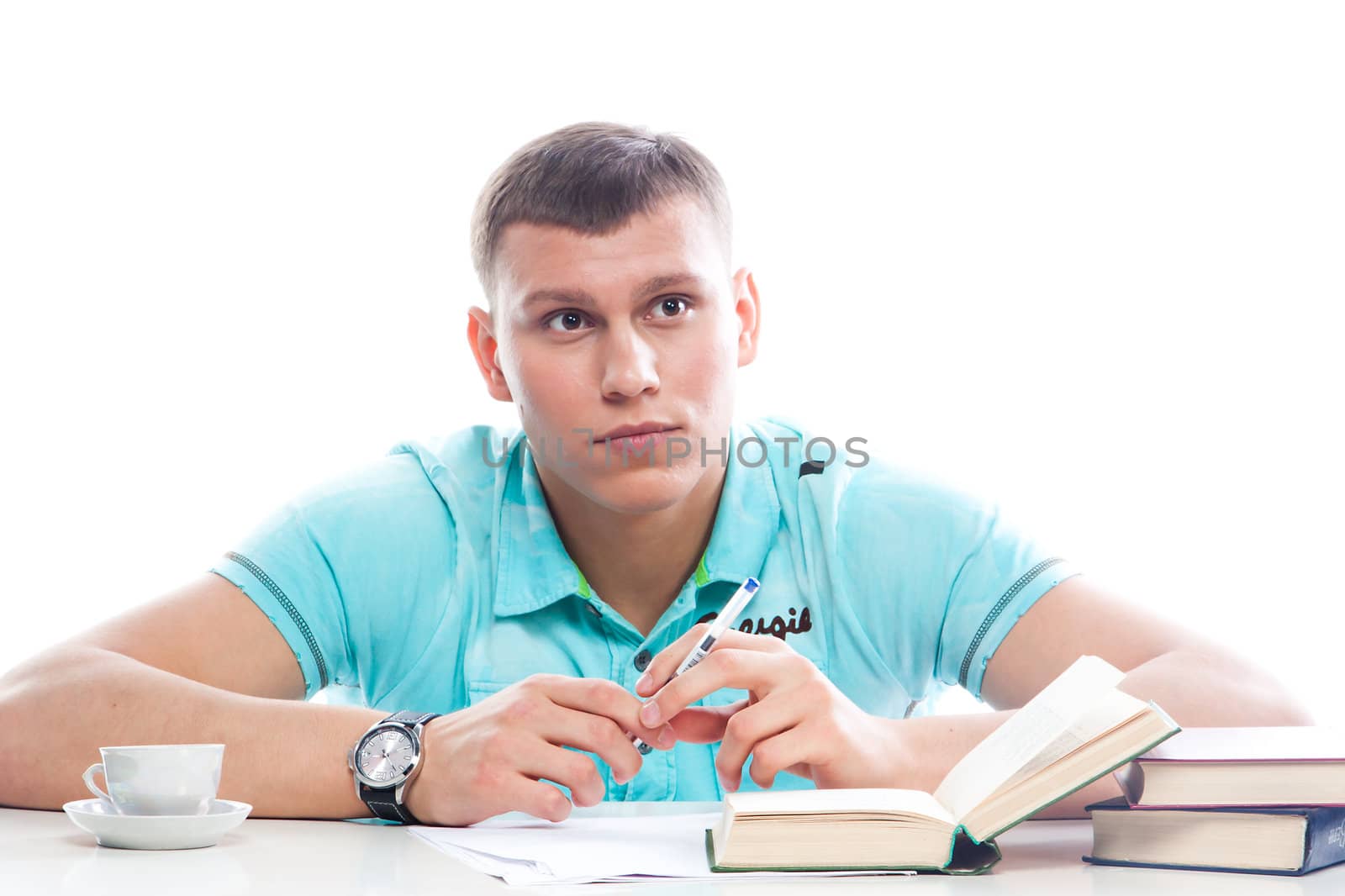 Portrait of a young attractive guy who is preparing for the exams at a university or college
