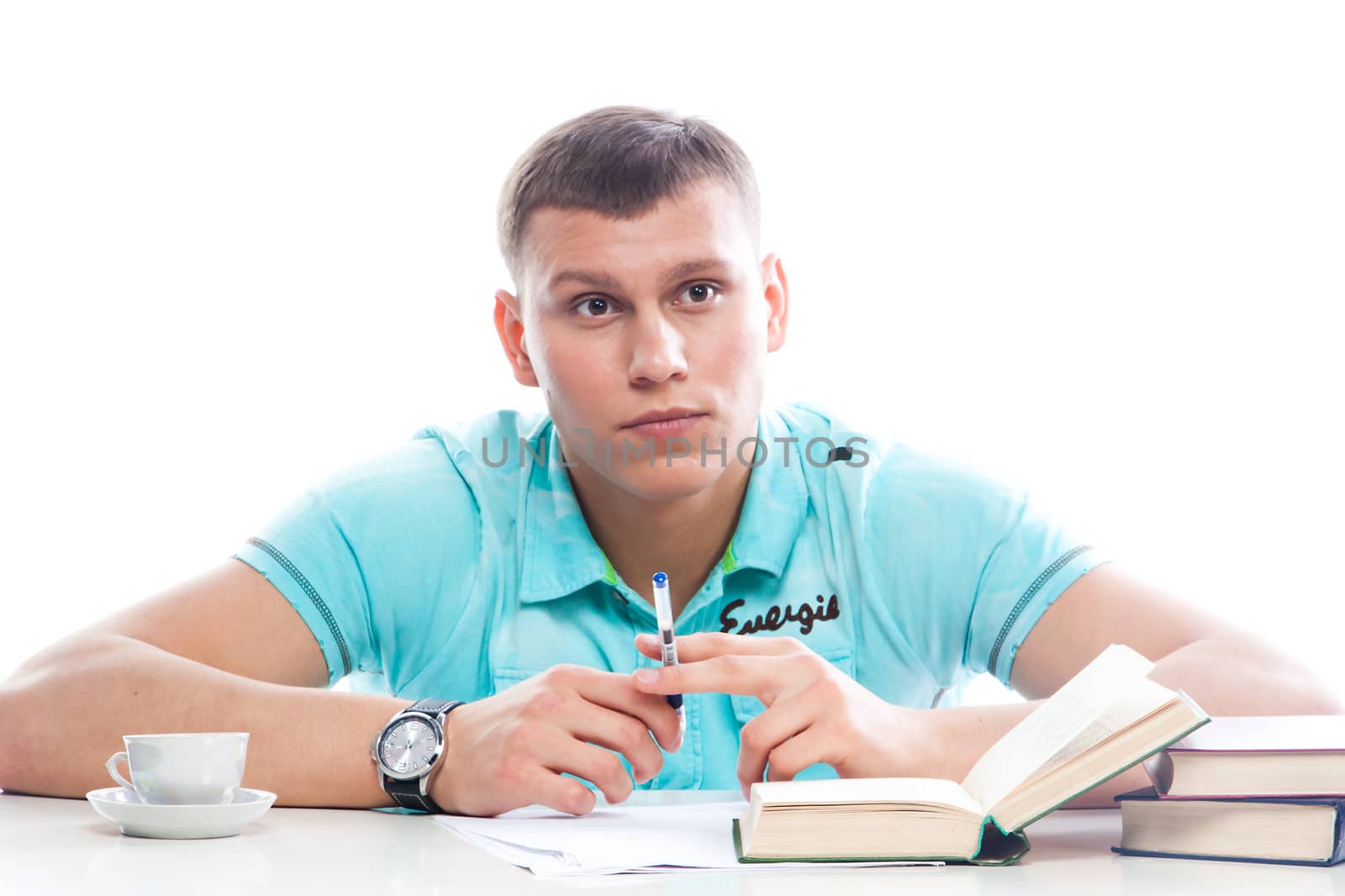 Portrait of a young attractive guy who is preparing for the exams at a university or college