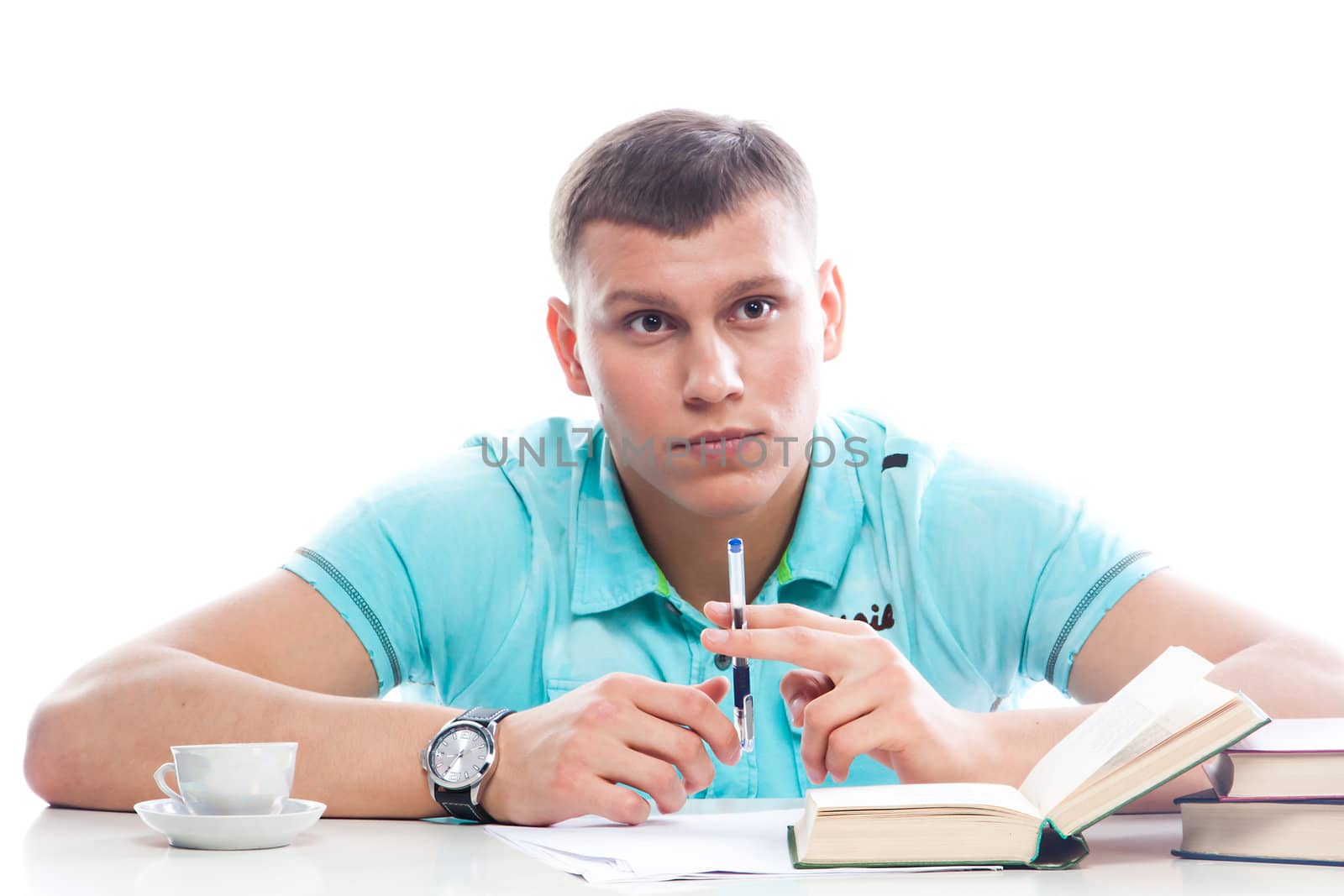 Portrait of a young attractive guy who is preparing for the exams at a university or college