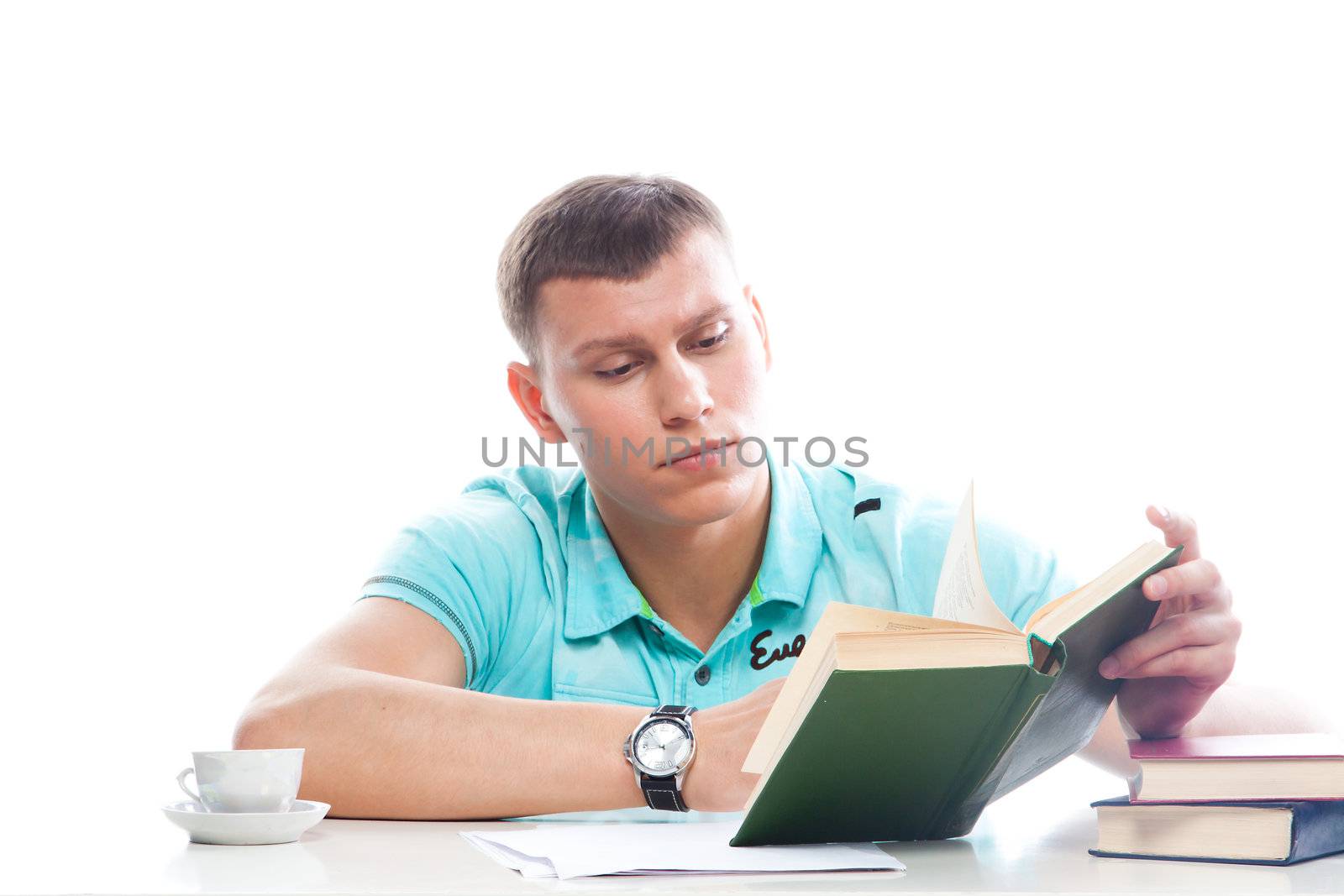 Portrait of a young attractive guy who is preparing for the exams at a university or college