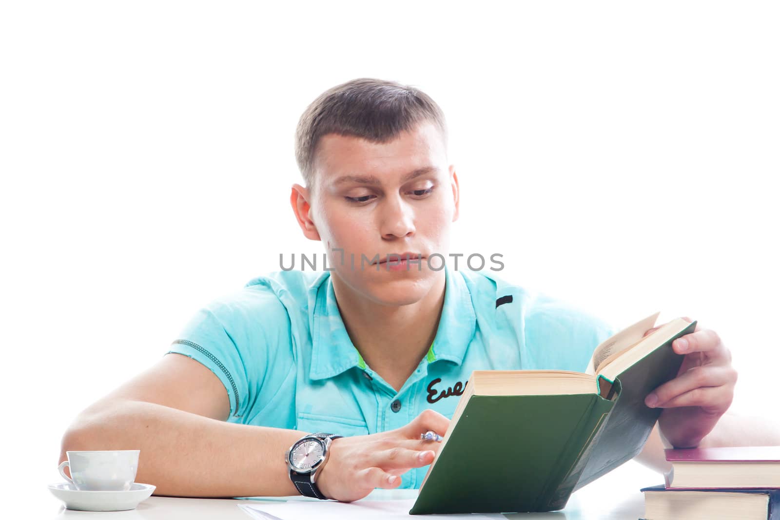Portrait of a young attractive guy who is preparing for the exams at a university or college