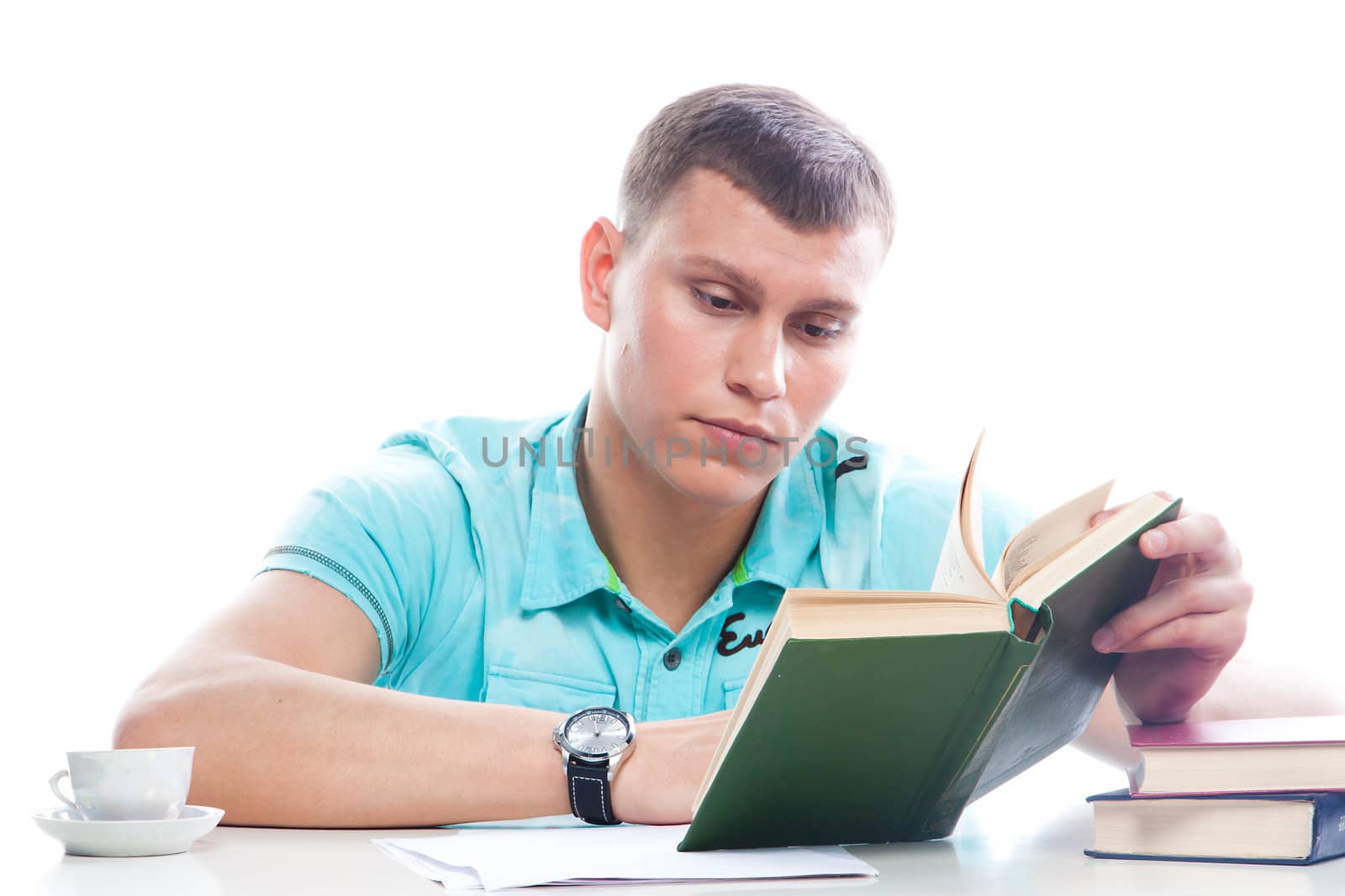 Portrait of a young attractive guy who is preparing for the exams at a university or college
