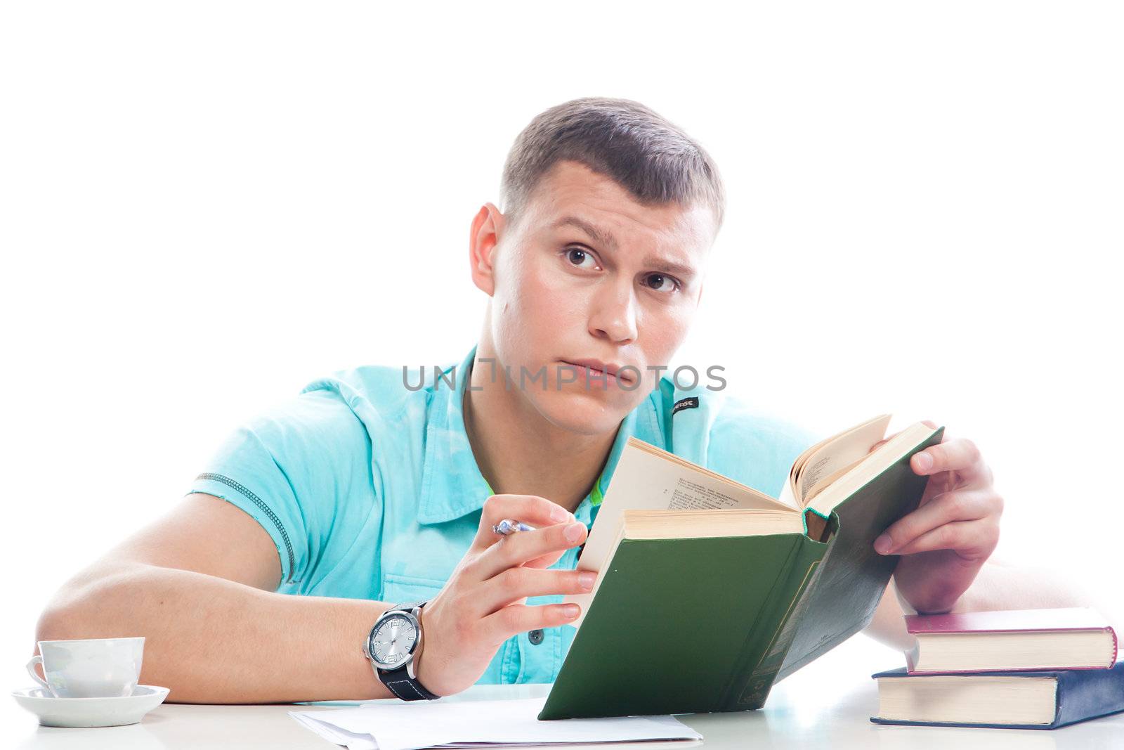 Portrait of a young attractive guy who is preparing for the exams at a university or college