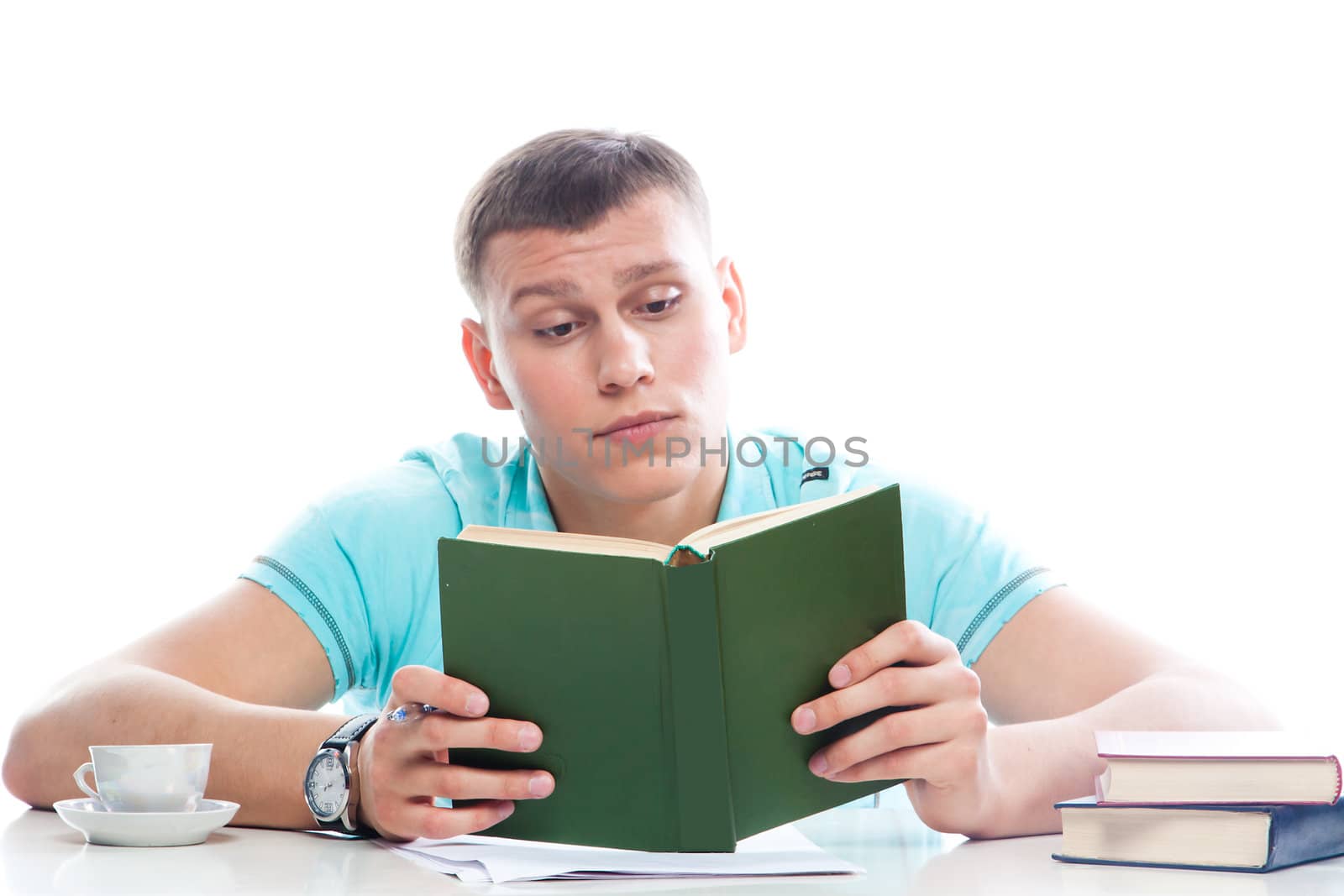 Portrait of a young attractive guy who is preparing for the exams at a university or college