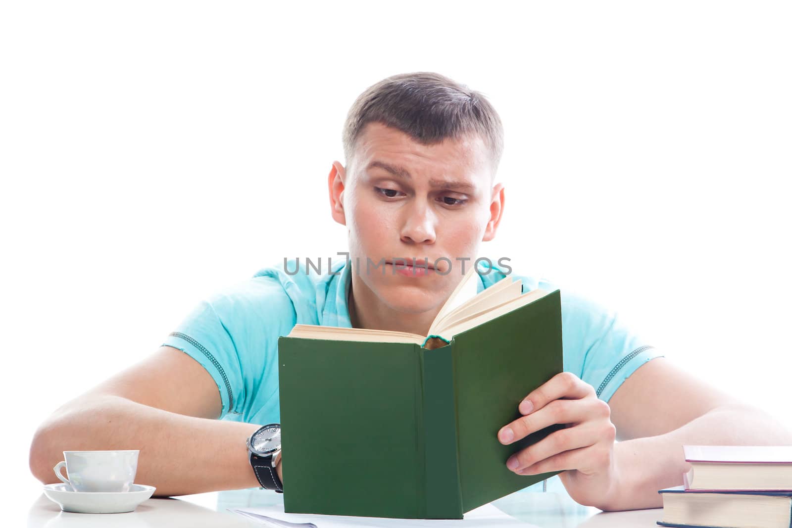 Portrait of a young attractive guy who is preparing for the exams at a university or college