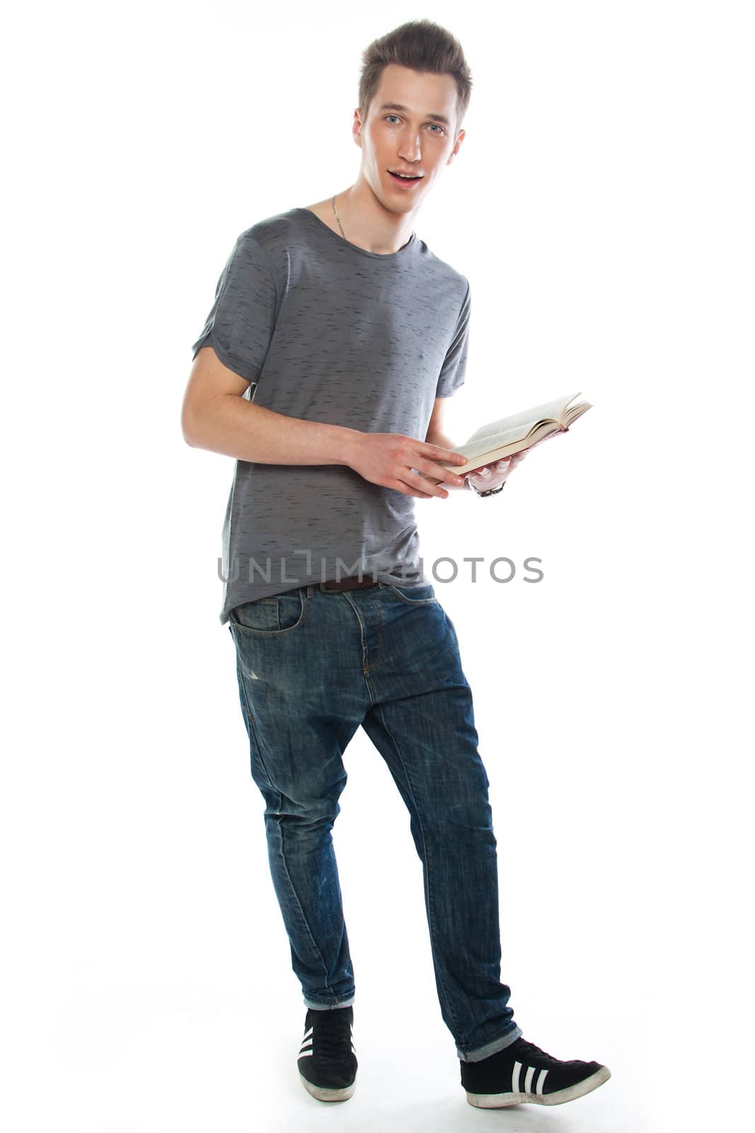 Portrait of a young attractive guy who is preparing for the exams at a university or college