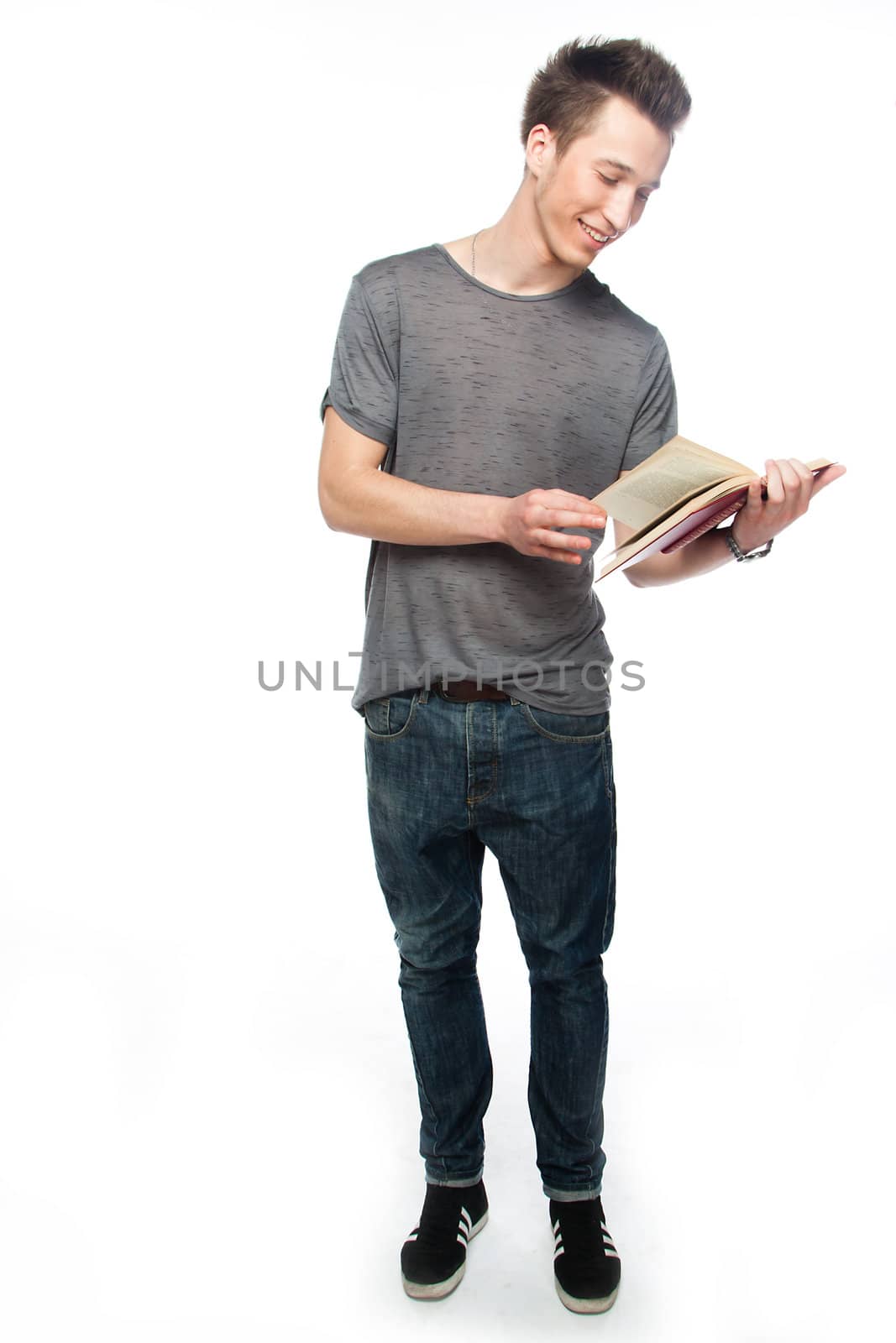 Portrait of a young attractive guy who is preparing for the exams at a university or college