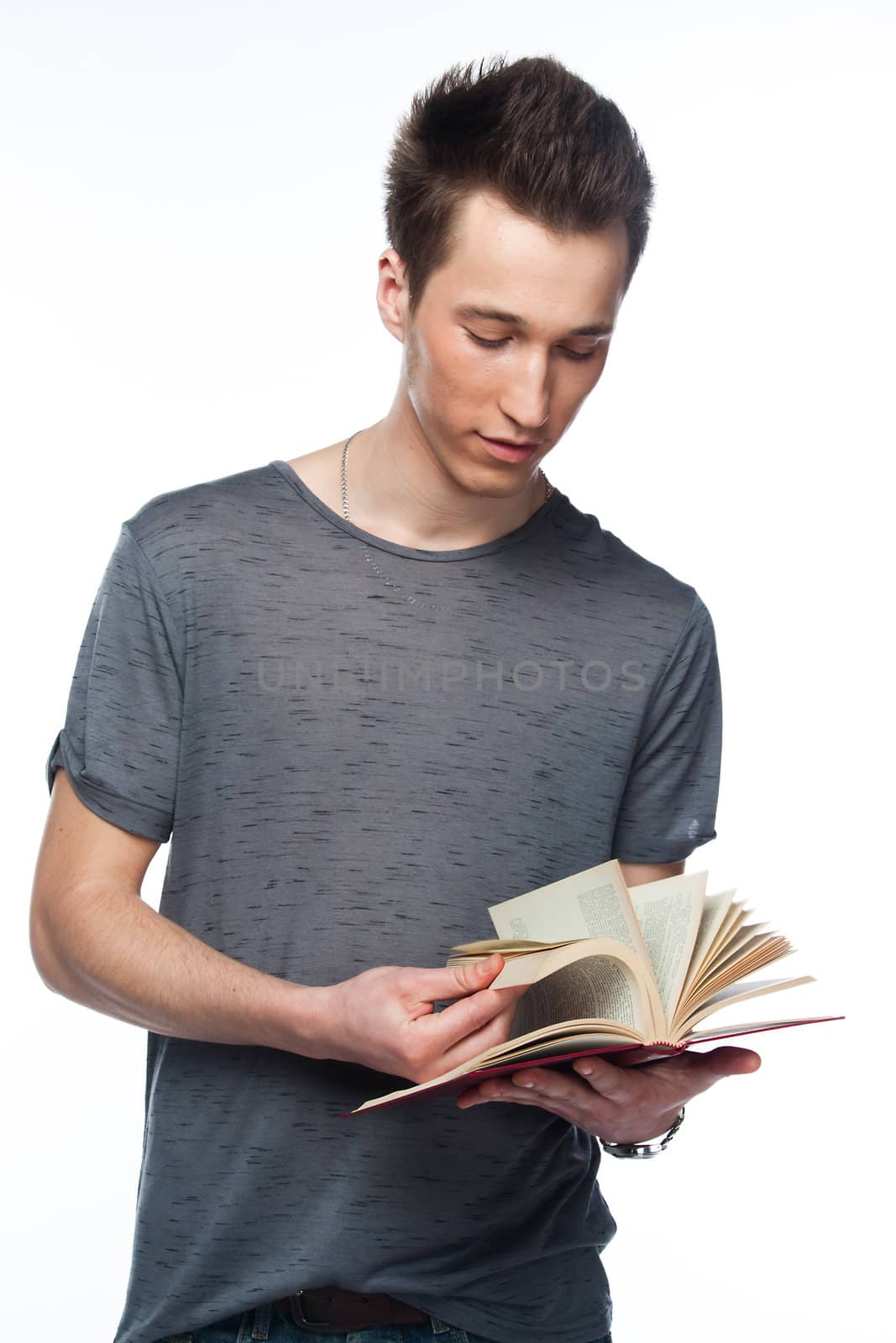 Portrait of a young attractive guy who is preparing for the exams at a university or college