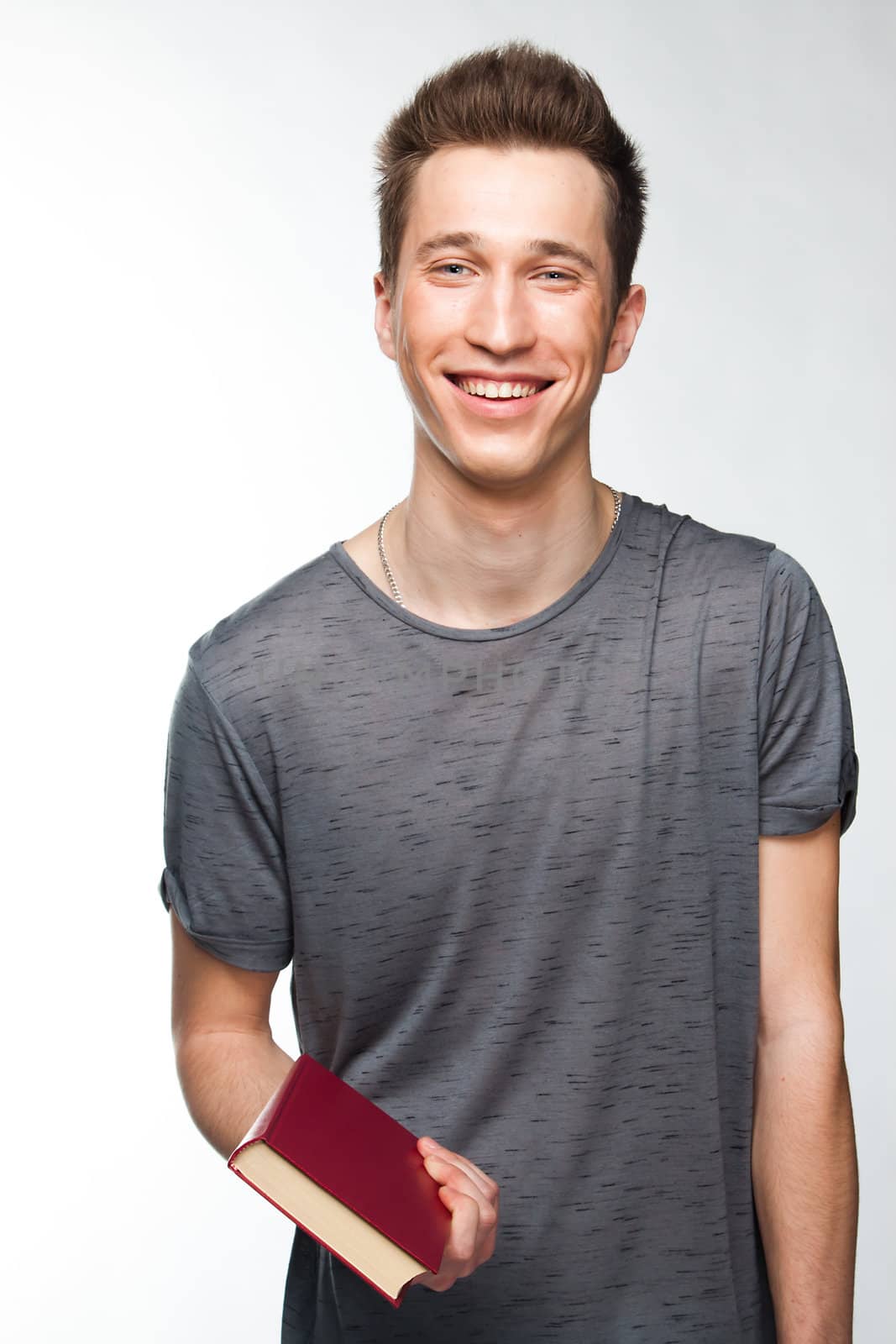 Portrait of a young attractive guy who is preparing for the exams at a university or college