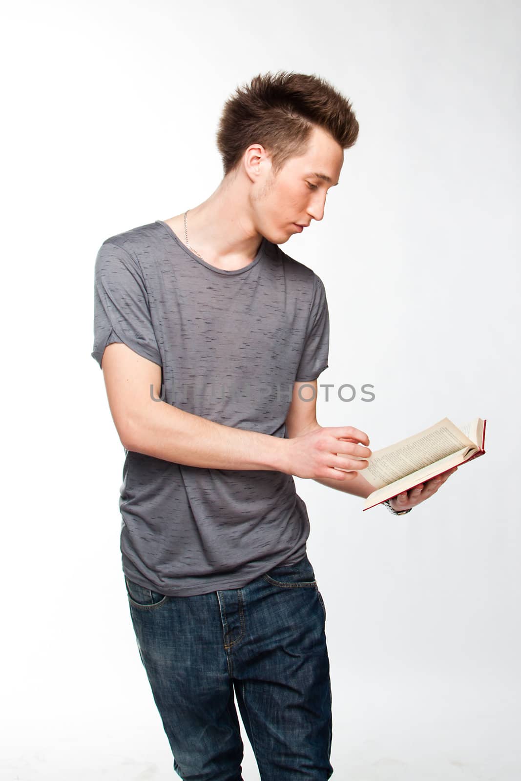 Portrait of a young attractive guy who is preparing for the exams at a university or college