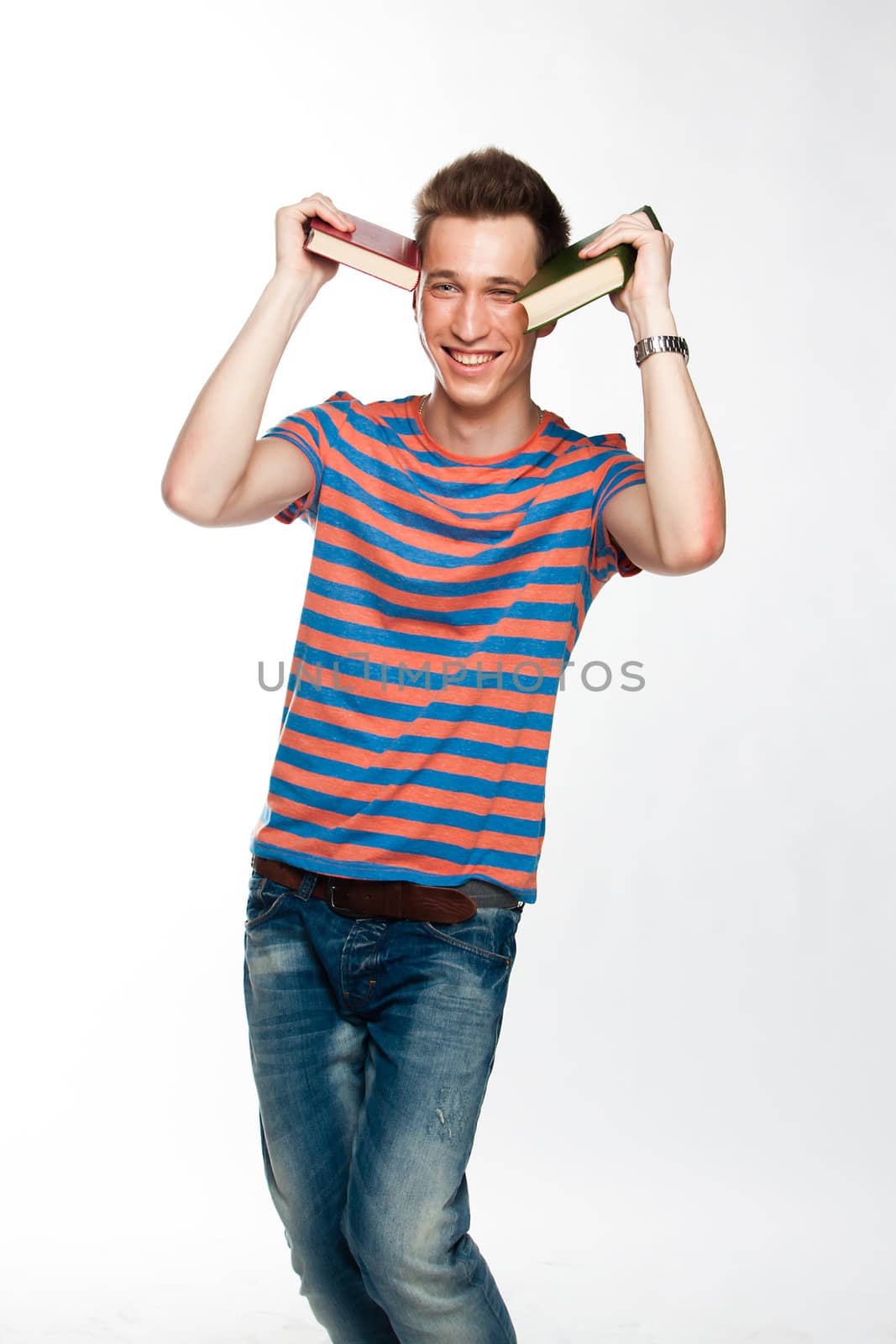 Portrait of a young attractive guy who is preparing for the exams at a university or college