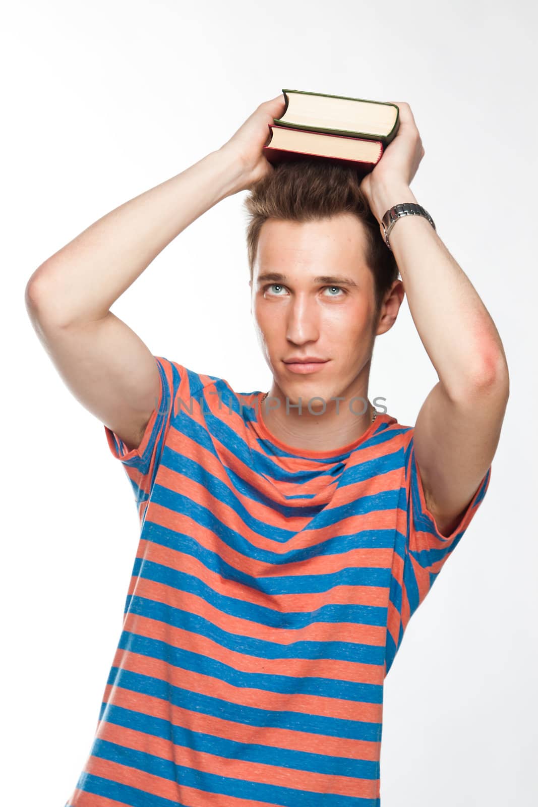 Portrait of a young attractive guy who is preparing for the exams at a university or college