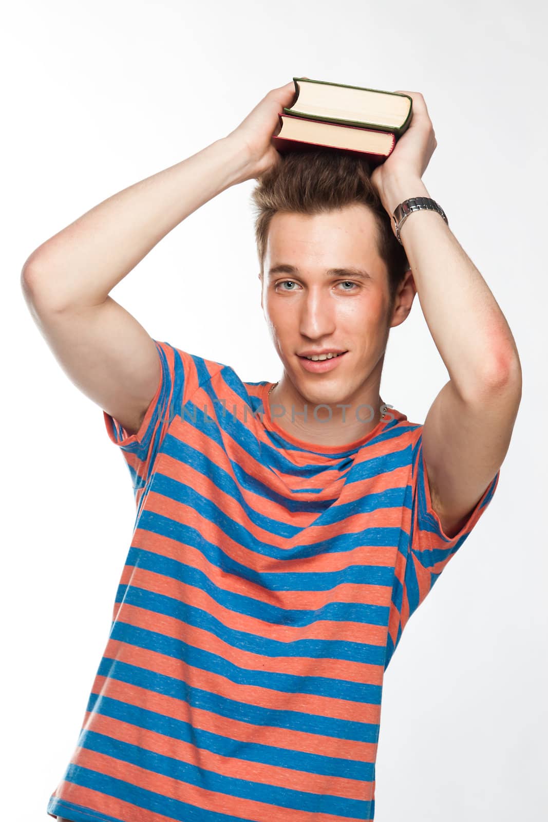 Portrait of a young attractive guy who is preparing for the exams at a university or college